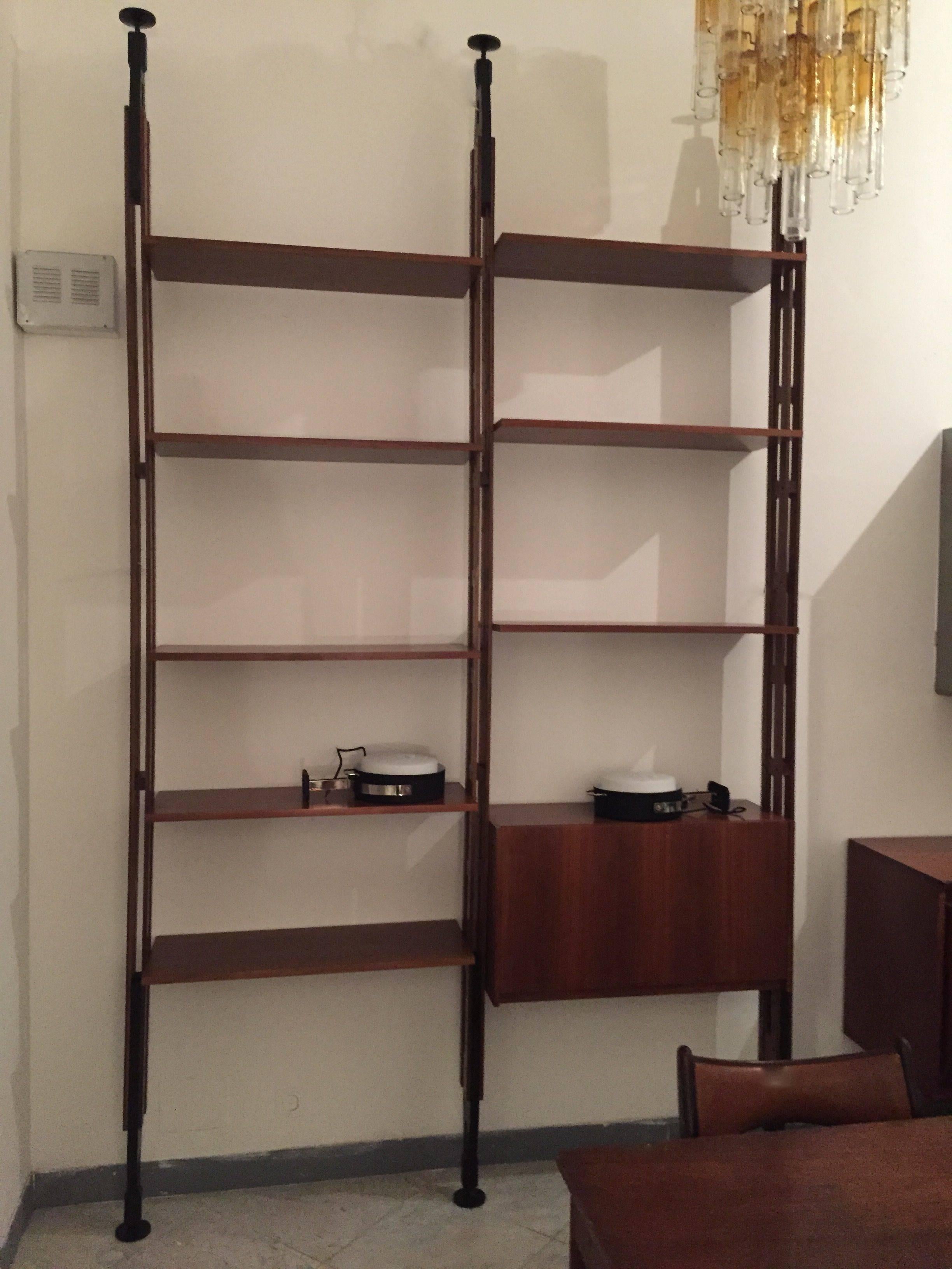 A floor to ceiling two section Italian teak bookcase produced in 1960  and designed by  Franco Albini. Framework in massif teak. Excellent condition.