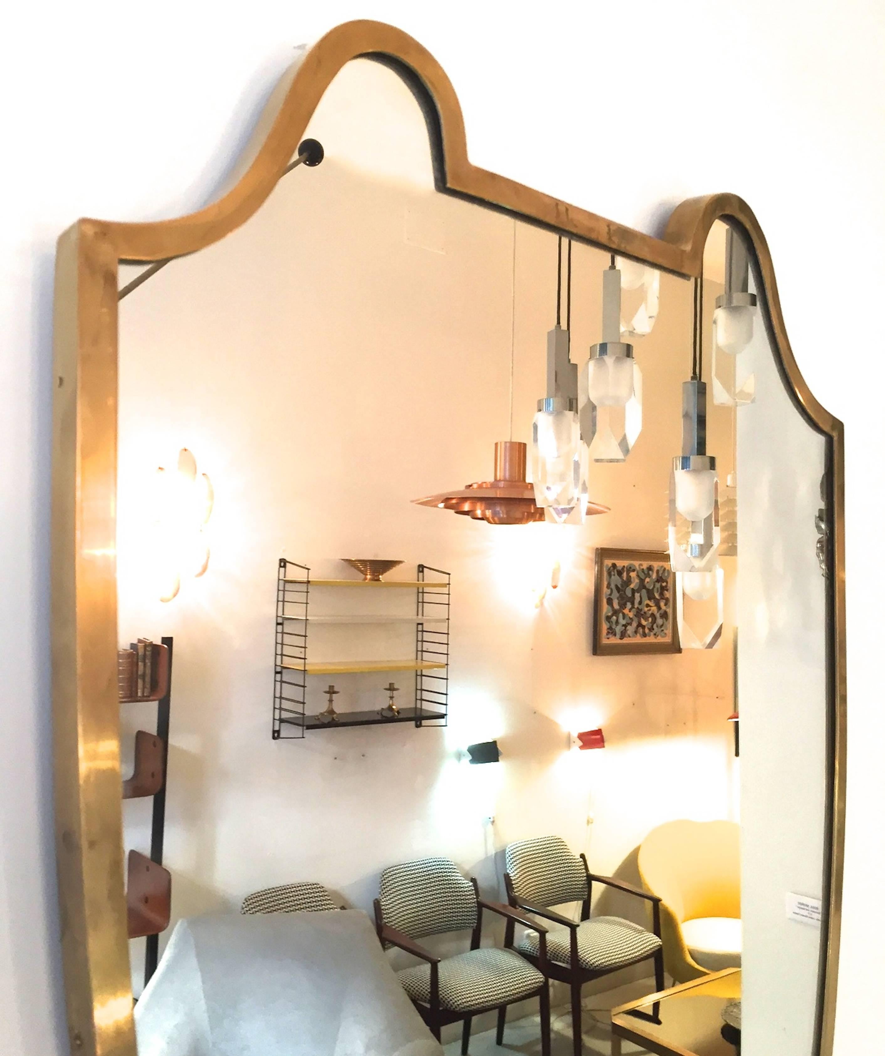 An Italian brass framed mirror. Original mirrored glass, 1950s.