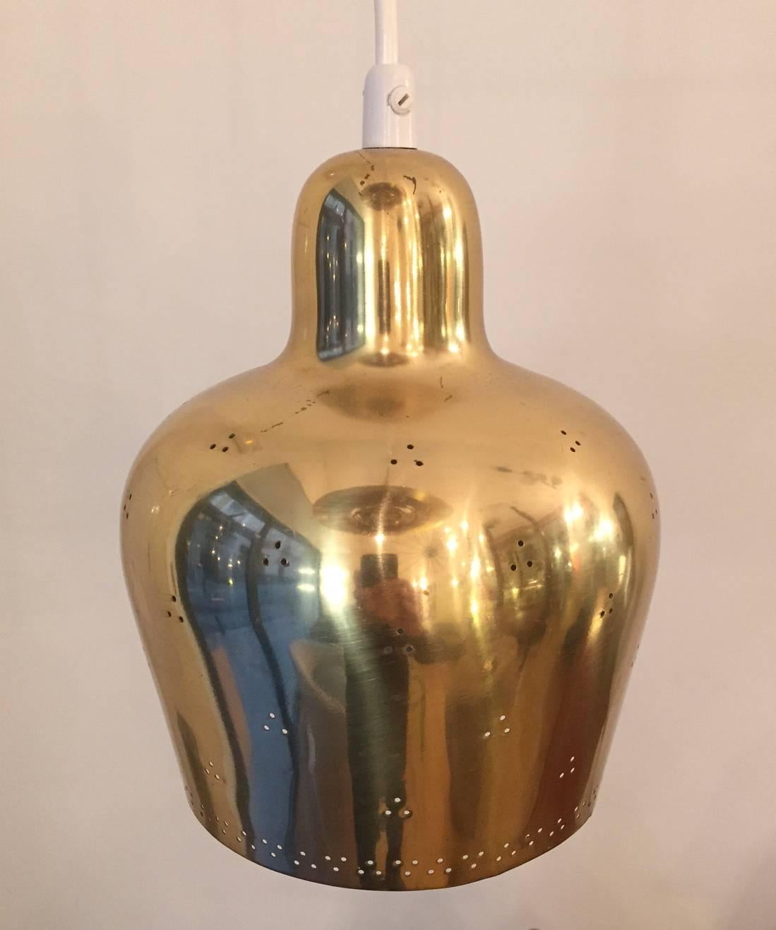 A polished and perforated brass pendant light designed jointly by Paavo Tynell and his pupil Alvar Alto and produced by Taito Oy in the 1940.
Excellent condition. Collection item. 
Shipping cost to anywhere in the world: 85 Euros.