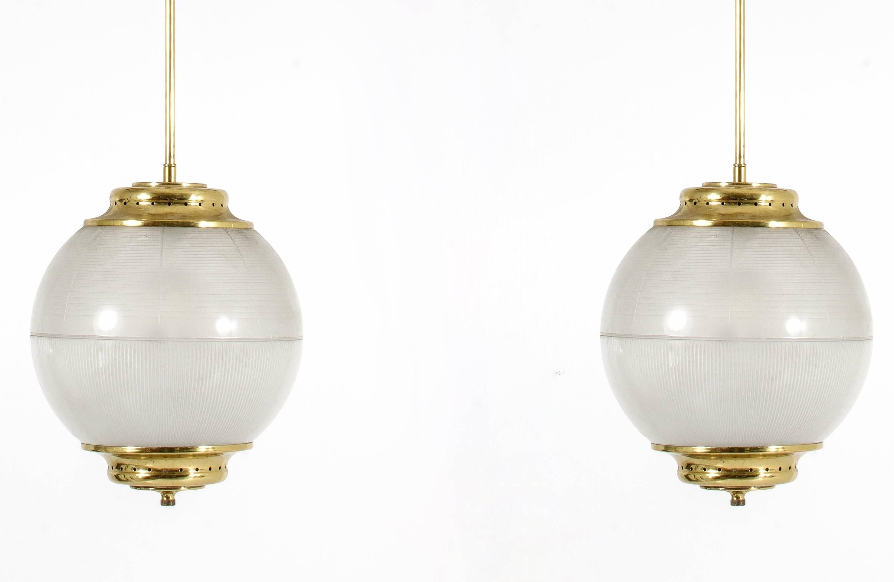 A pair of Sergio Mazza style chandeliers manufactured in 1950. Pressed glass shades and brass frames.
Excellent condition.