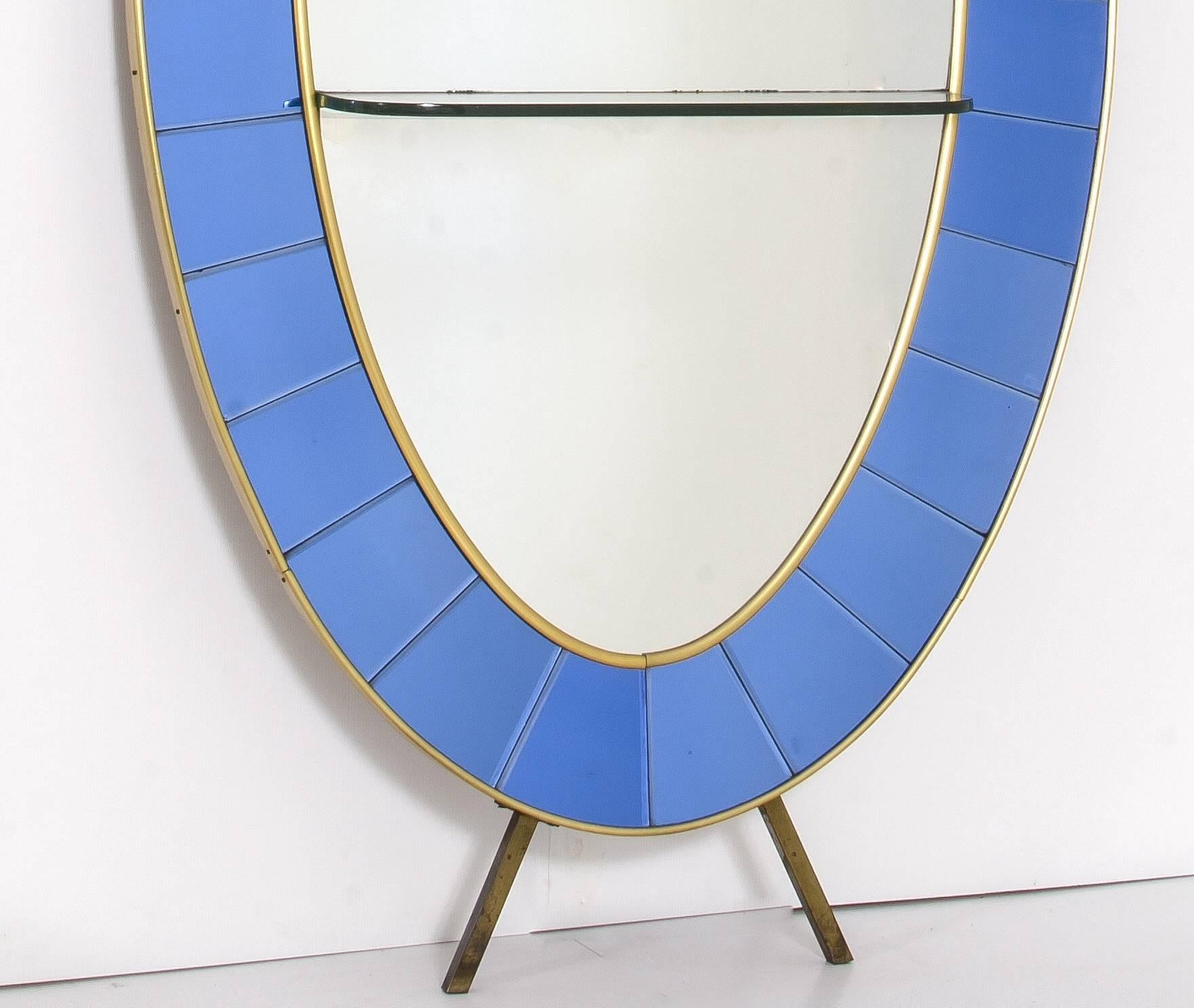 An standing oval mirror console by crystal art 1960. Thick cut-glass console. Mirror glass frame, anodized brass and light blue crystal-coled ground.
Excellent condition. pp.
  