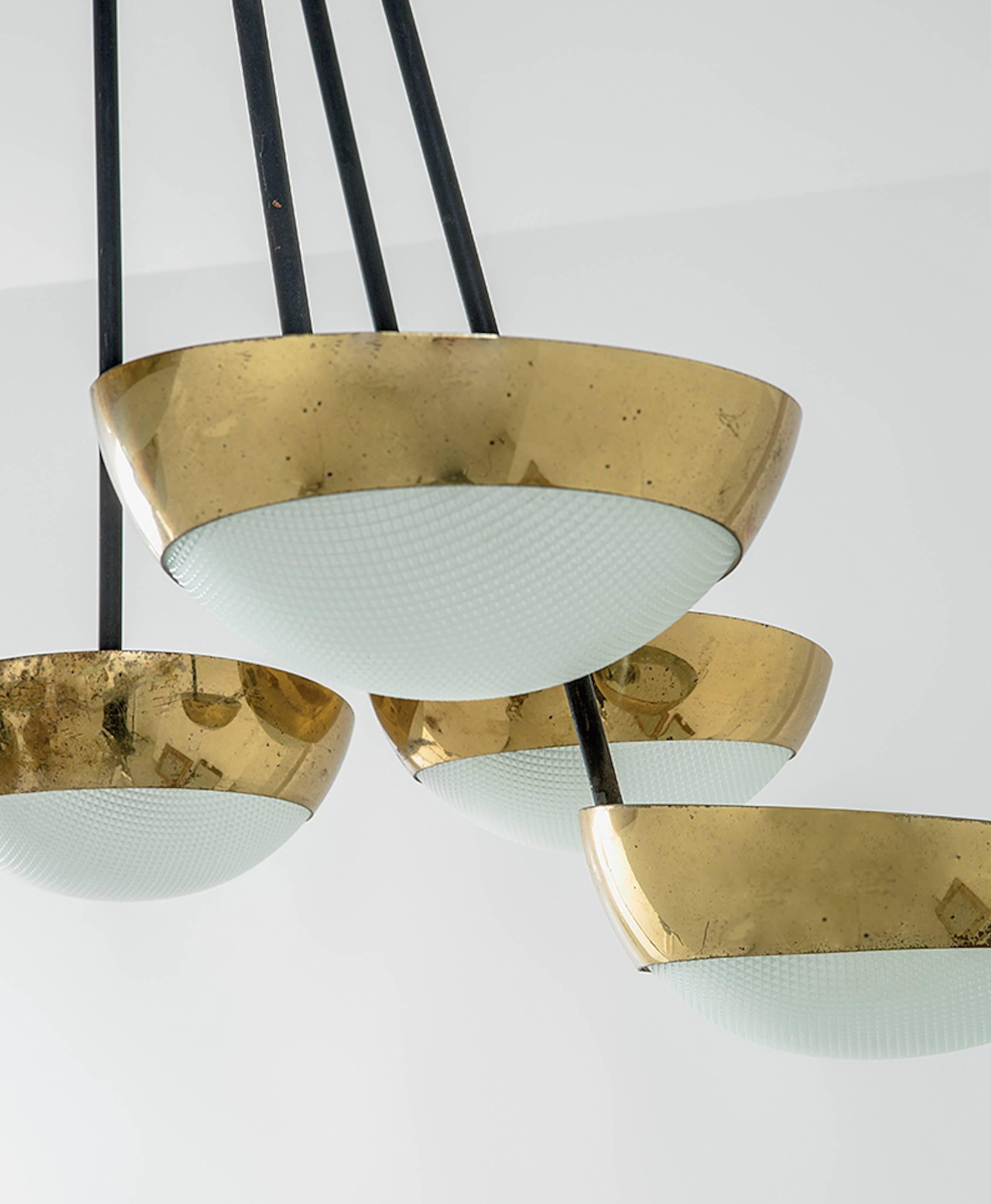 An outstanding fully original Stilnovo seven shade chandelier edited in 1960. Bras and curved, printed and satiated glass shades. Enameled metal and brass canopy.