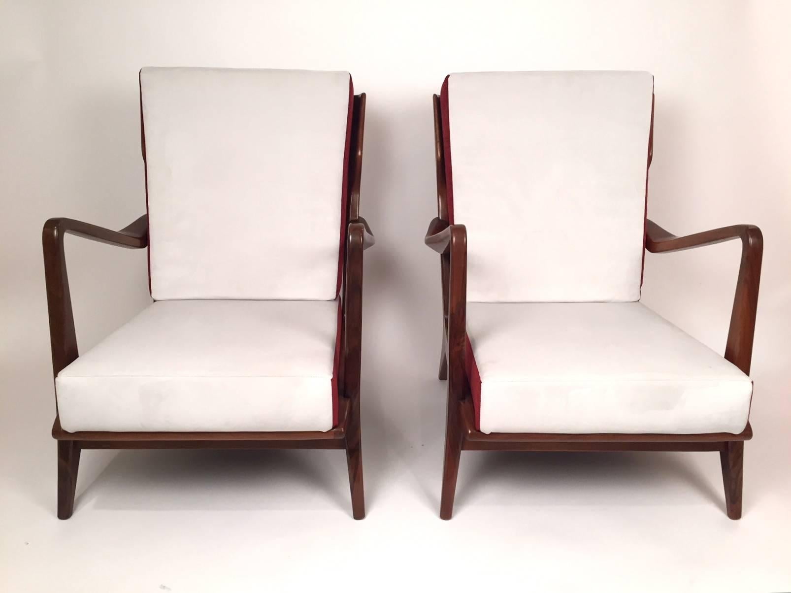 A pair of armchairs, model 516 , designed by Gio Ponti and edited by Cassina in the 1950s.  Walnut wood and fabric. Upwards rising arms and vertical open slats on the back.
Each chair has at the reverse a metal label stating :