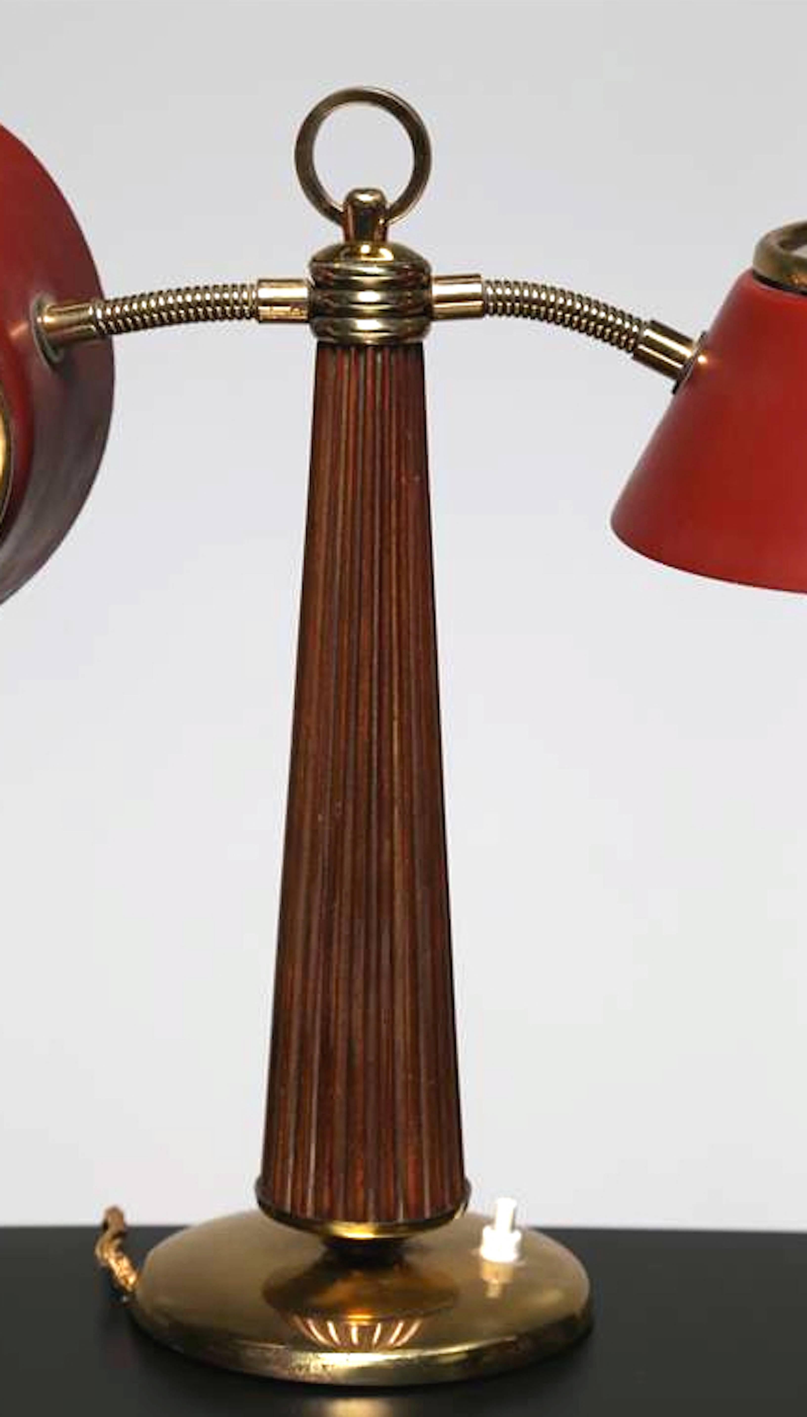 A very rare table lamp attributed to Arredoluce in 1950. Brass, lacquered metal, wood and satinated glass. Red adjustable shades.Free professional packing and shipping is provided.