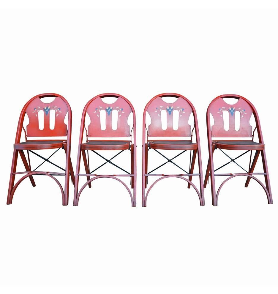 Made by the venerable Louis Rastetter & Sons furniture company, this table and chair set includes four red-stained oak folding chairs, boasting some of the charming design elements of Mr. Rastetter's native Germany. While the chairs were