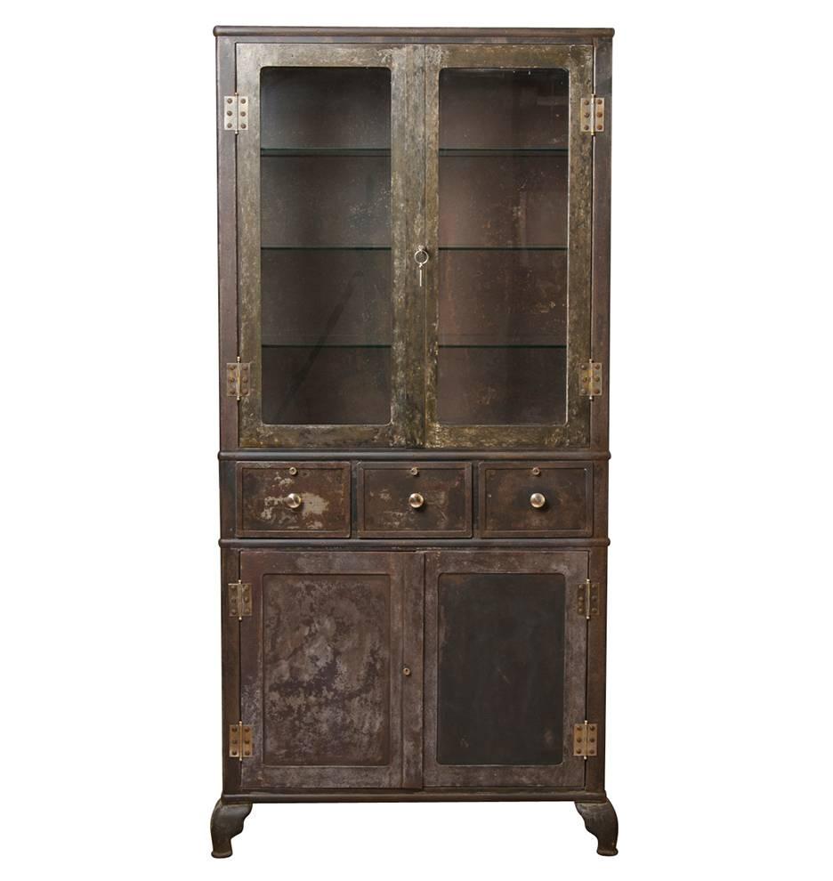 Durable and fireproof, metal furnishings were commonly found in hospitals and doctor's offices from the turn of the century through the 1930s. This Classic example of early medical furniture features heavy-duty steel construction, an upper cabinet