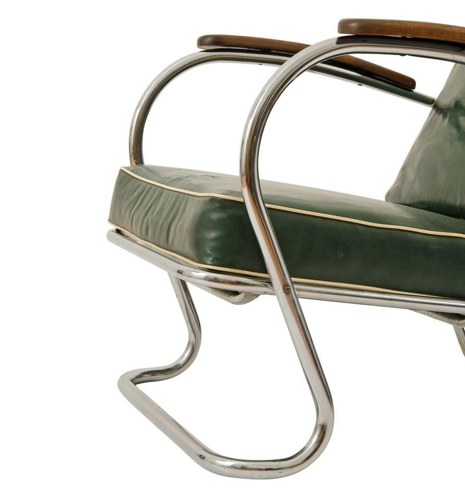 What could be better than a wonderfully intact vinyl and chrome armchair? How about one that also features natural wood armrests? This well-preserved mid-century beauty likely comes to us from a barber shop, where chairs like this would have lined