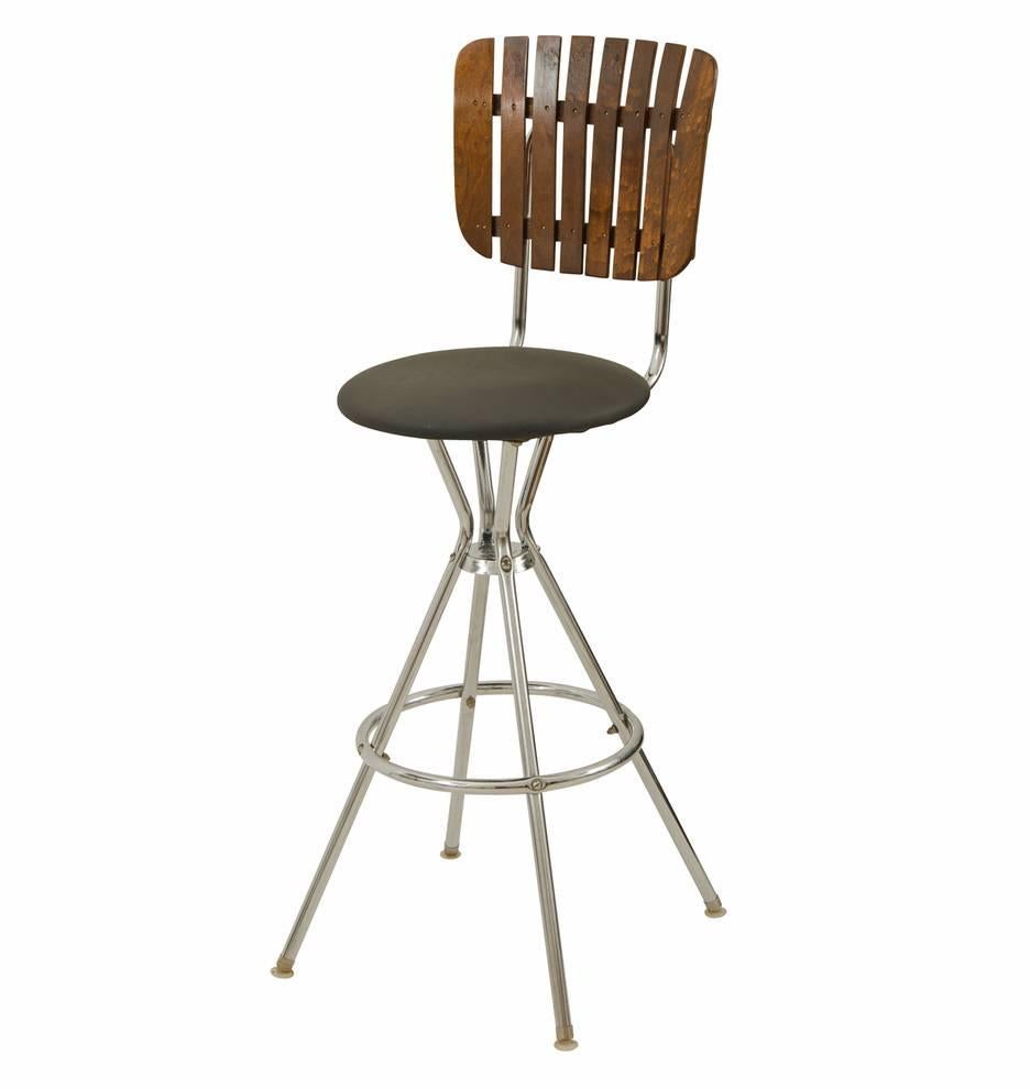 We love the clean modern lines of this set of six steel and oak kitchen stools, which were designed by Arthur Umanoff. The simple design is complimented by a few thoughtful details, including the oak slat backs, polished chrome tubular bases and