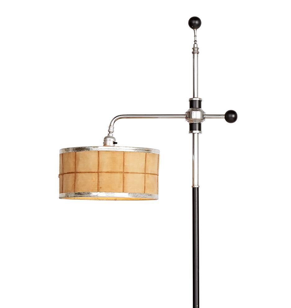 Designed by Gilbert Rohde, likely for Mutual Sunset Lamp Company, this incredible floor lamp features polished chrome and ebonized black components and original paper drum shade with chrome trim. Design elements include tiers and balls, from the top