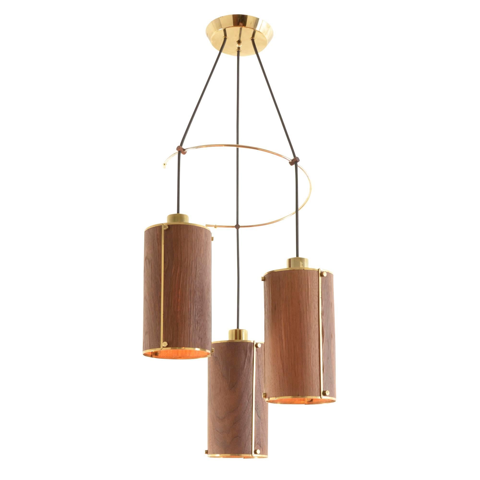 This chandelier is a fine example of a trend within a trend. The streamlined Modernism of the 1950s and '60s branched off to include a stylized review of natural and traditional materials, combining them with innovative (and often experimental)