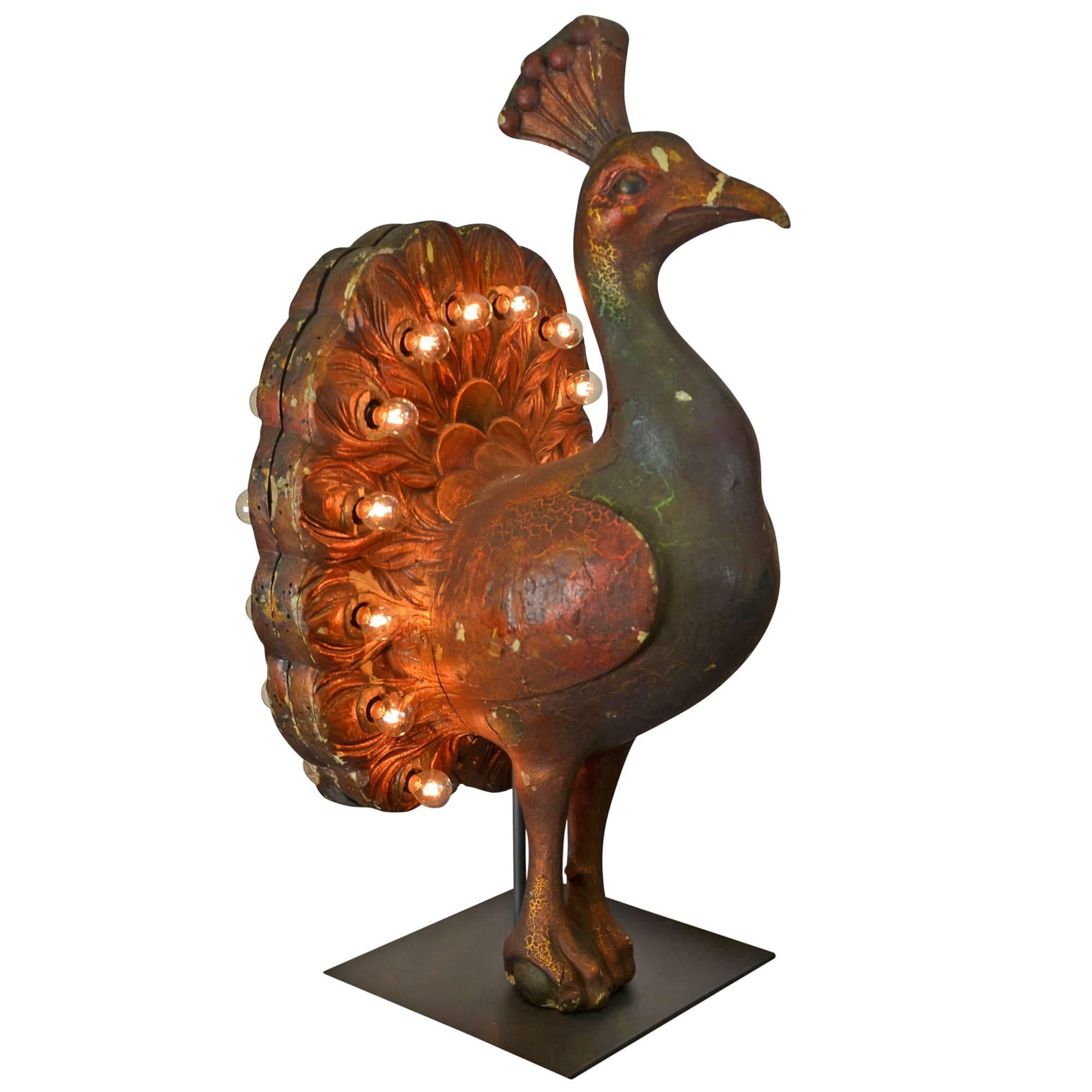 A rare bird, if there ever was one. Completely unique and one of the most unexpected finds we've ever come across, we believe this piece to have been the focal point to a carousel in its day. Hand-carved from wood and outfitted with 28 bulbs