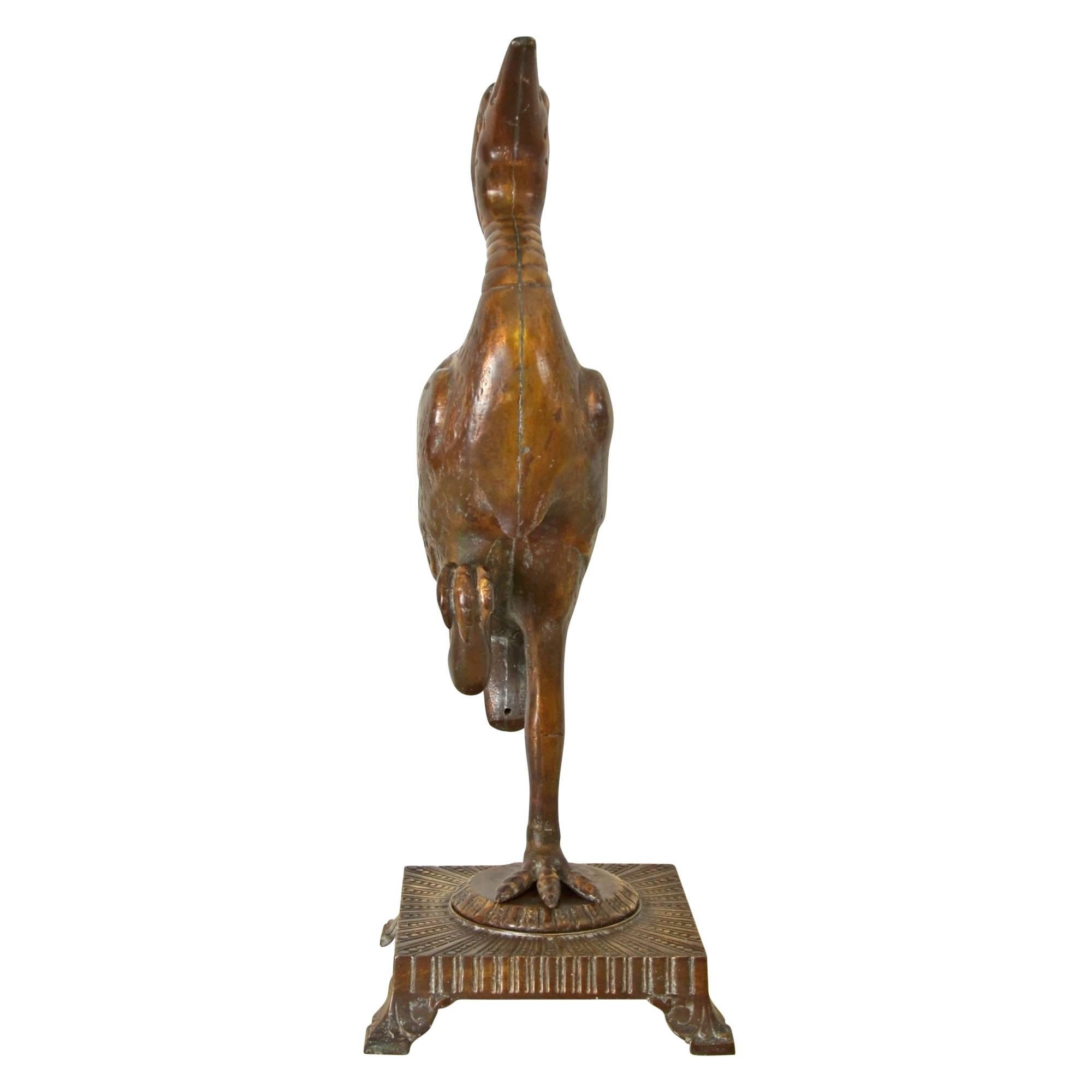 Produced by the F.G. Company (best known for making cast brass and iron lighting parts at the turn of the last century), comes this remarkable red brass egret statue. With incredible detail, the proud egret stands in a characteristic pose,
