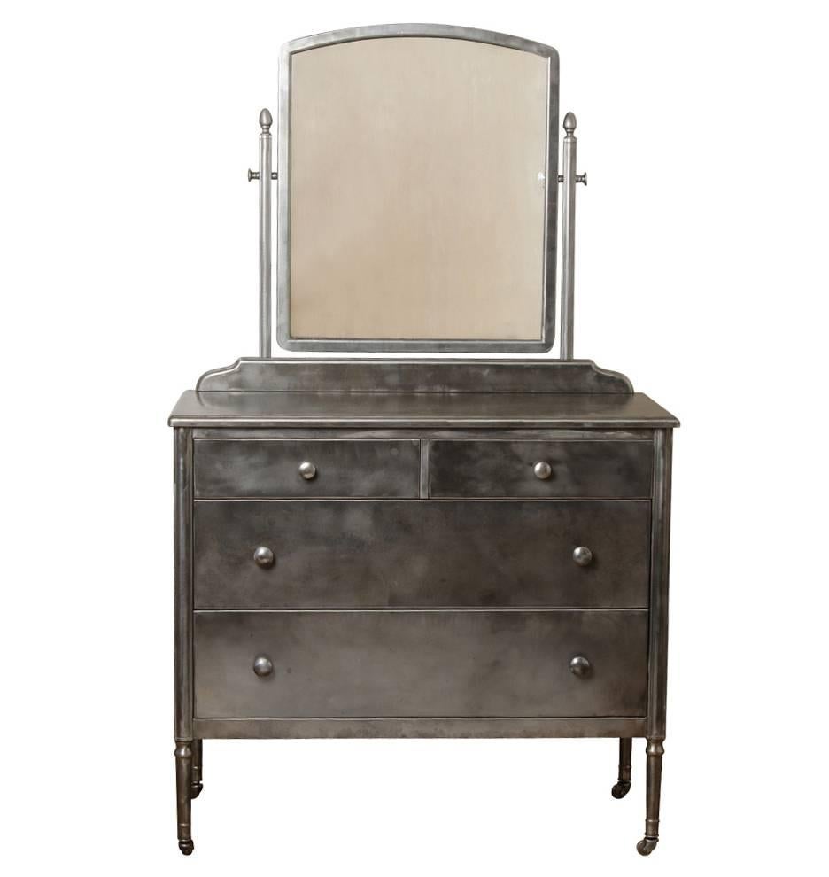 Durable and fireproof, the Simmons Manufacturing Company was best known for making pressed steel furnishings in the most popular styles of the day. This example hails from their Classically-inspired Sheraton series, which was produced in Simmons'
