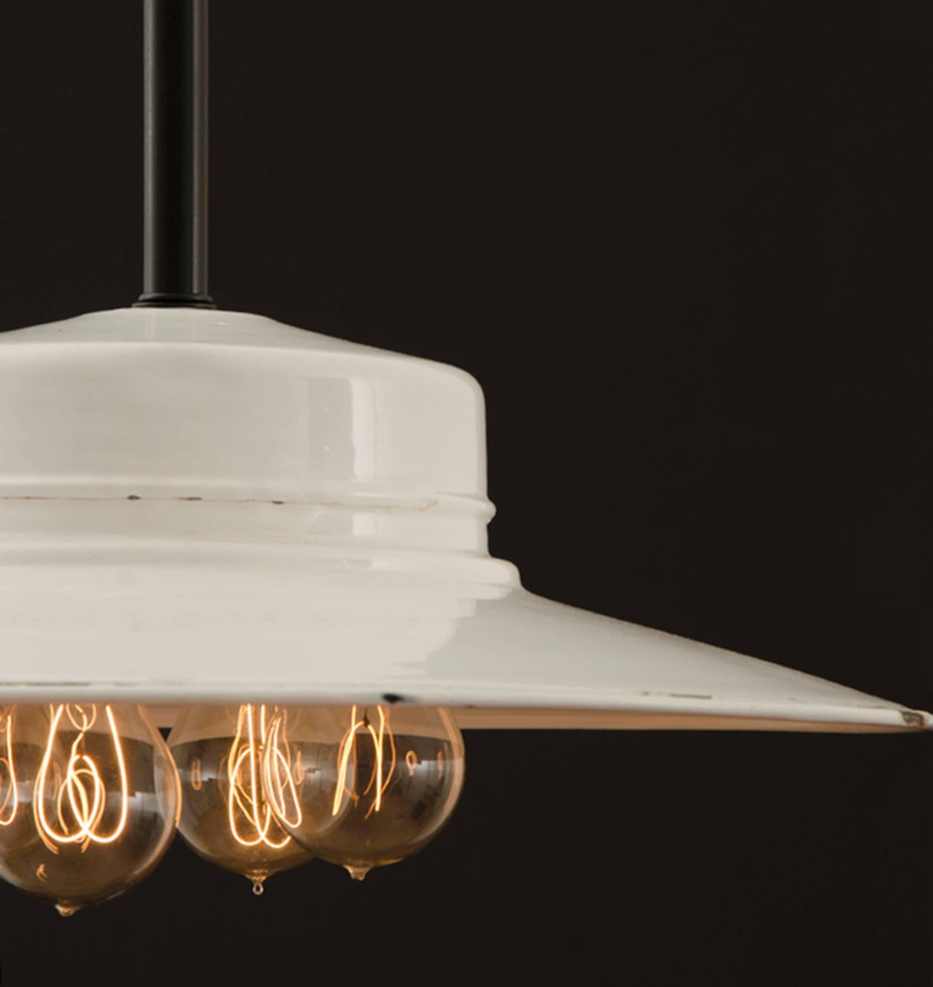 This Industrial pendant checks all the boxes for the most desirable antique Industrial lighting. Unusual design, a porcelain enamel reflector, and an early electric socket cluster all come together in this rare and unusual example from Chicago's