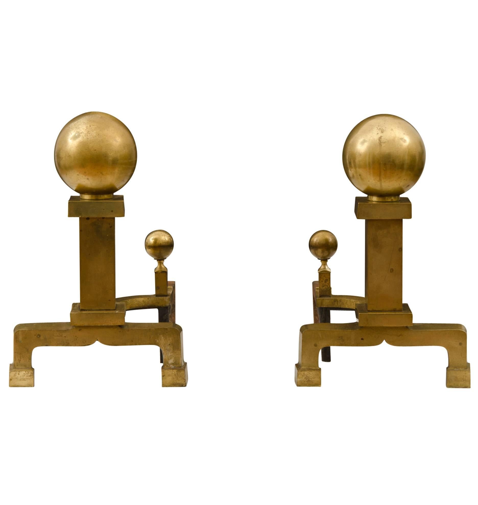 This pair of New England cast brass andirons dates back to the mid-19th century and comes with all of the wonderful symmetry and stately simplicity of the Federal period. They have even more history than that, though: these came from the estate of