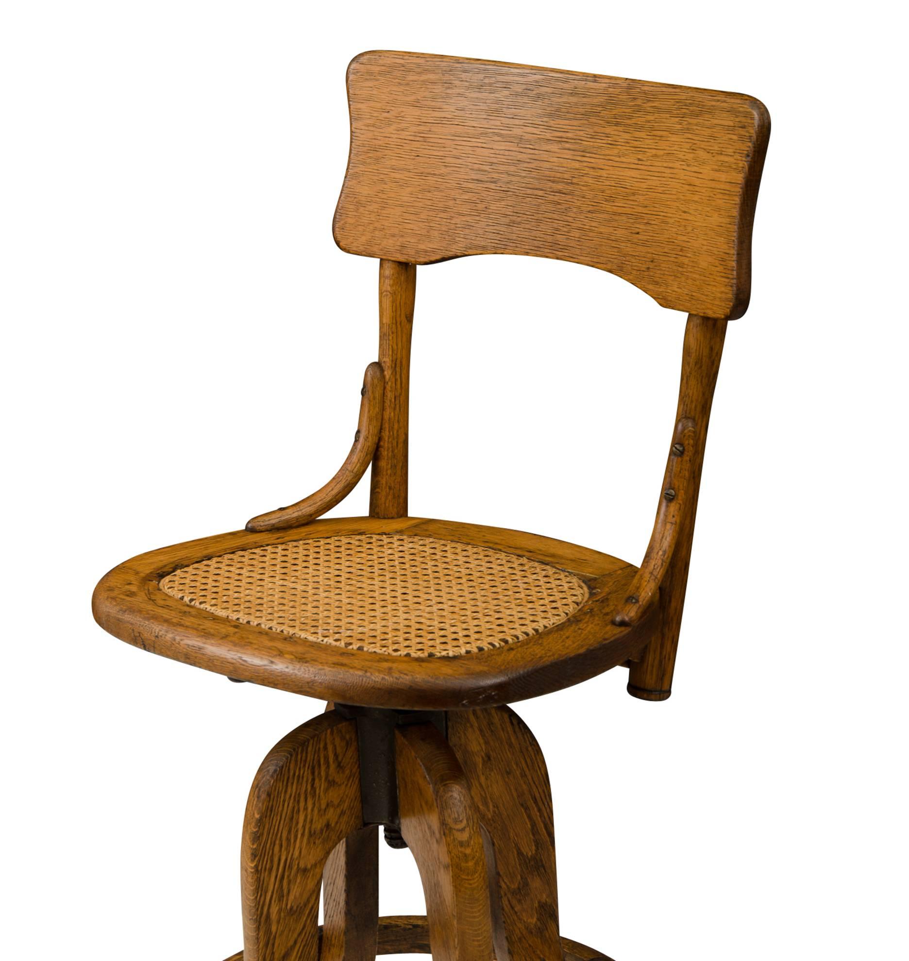 Industrial Oak Operators Stool with Caned Seat, circa 1925 For Sale