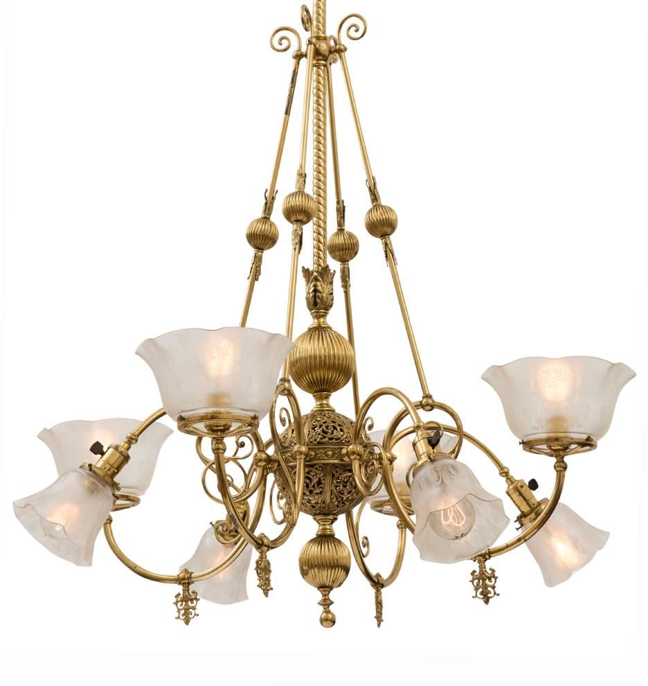 A rare survivor from the turn-of-the-century, this now fully-electrified eight-light stunner has all the transitional character that makes lighting of the early 1900s so interesting. Delicately cast ornamental armbacks gracefully complement the