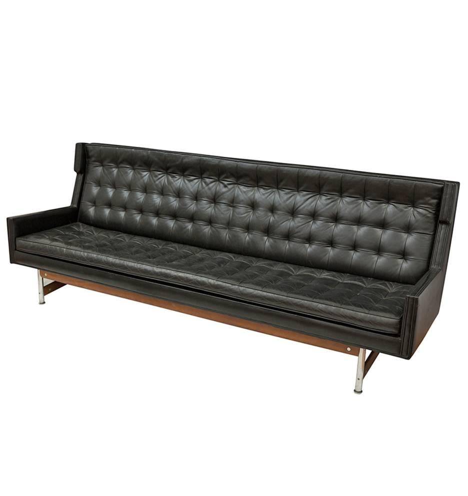Eight feet of leather, polished aluminium and walnut, comprising a beautifully tufted Mid-Century sofa. Note the mini-wing-back design, the perfectly tilted seat angle, making for a very comfortable resting place.

This fantastic Mid-Century relic