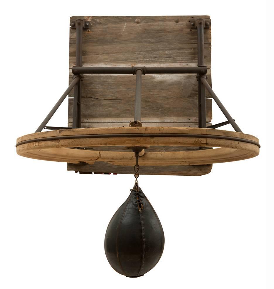 It's easy to imagine Benny Leonard or Jack Johnson getting warmed up under this fantastic relic of the early American boxing era. Comprised of an enormous pine ring (the size of a wagon wheel) with and adjustable tubular iron framework. With the