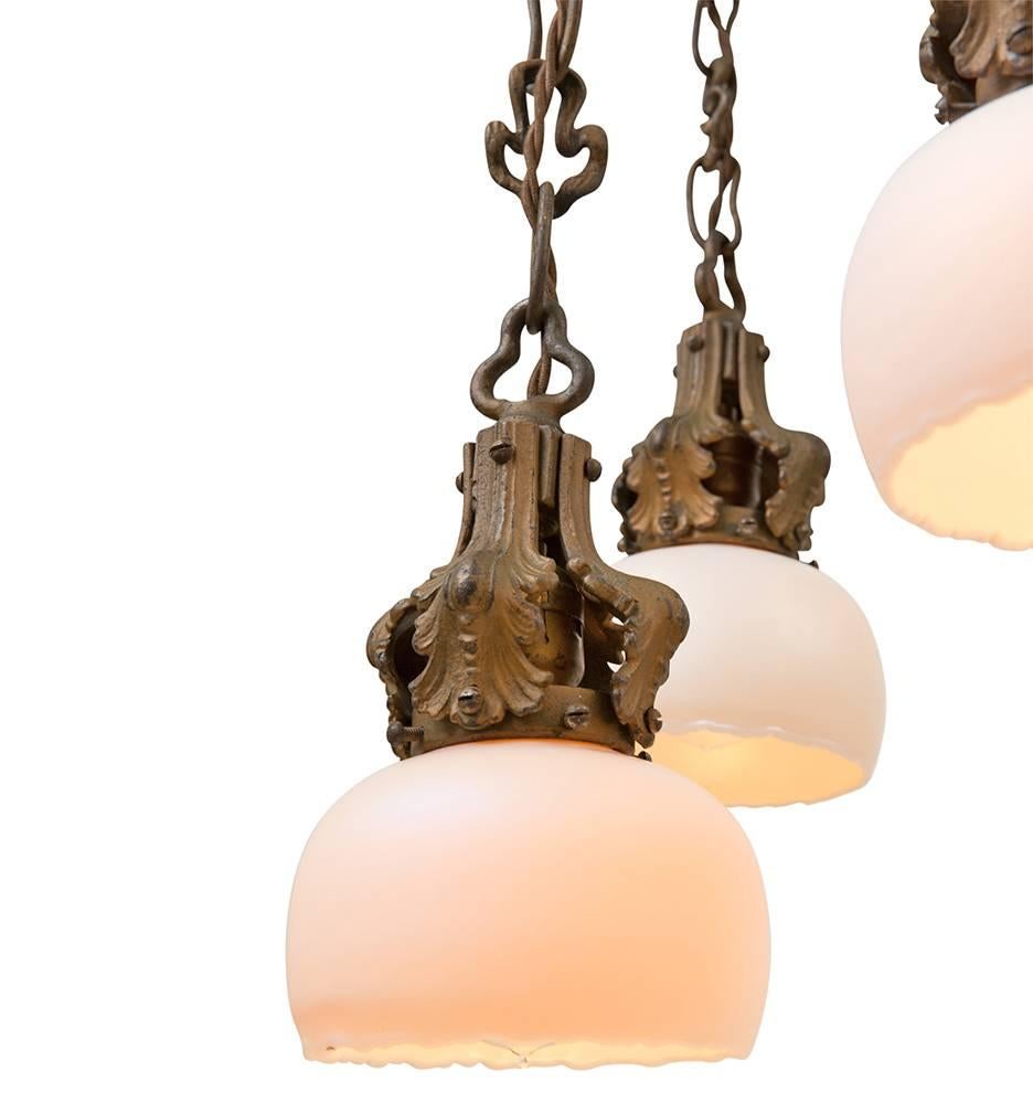 An incredibly rare and unique piece, this stunning light fixture is unusual in its design, material and style. Made from cast iron and finished with bronze gilt, this fixture hails from the turn-of-the-century Art Nouveau movement. Organic