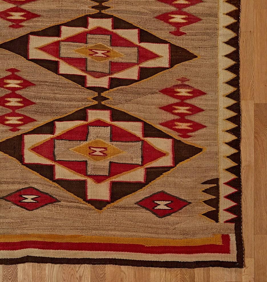 This gorgeous Navajo rug features the Red Mesa repeating diamond motif, bordered with zigzag patterns. Red Mesa was a trading post in Arizona, and the rugs from this outfit were known for their precision and intricacy. 

Truly a unique piece, this