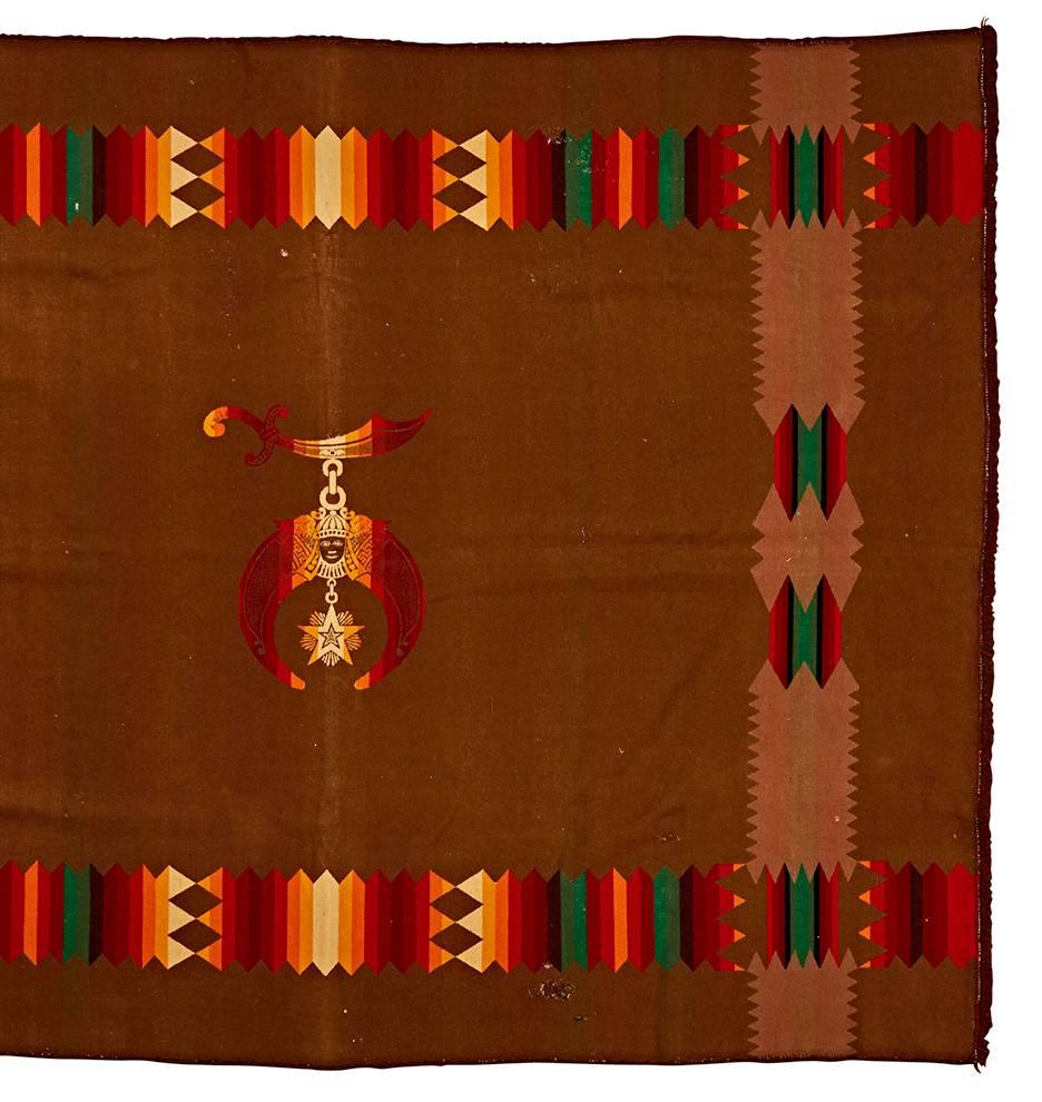 The Order of the Eastern Star is an appendage of the Masonic Fraternity (Free Masons), which is open to both men and women. This remarkable blanket features vertical stripes, interwoven with crystal patterns. In the center, the medallion of the