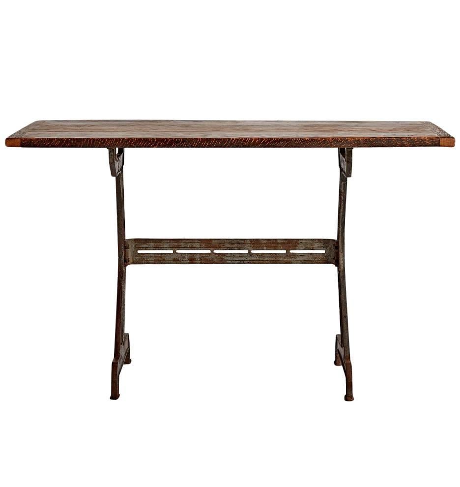 With a unusual cast iron base, made from three sections, this table has a hardworking, futuristic style that allows it to straddle both Industrial and Streamline-era camps. Would make a nice minimal desk or stylish console. Topped with a rough-sawn
