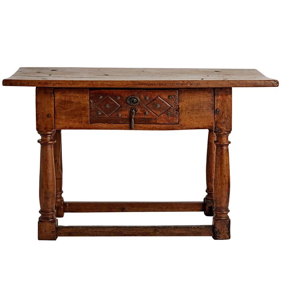Found on a recent trip to Europe, this incredible 17th century Flemish table is hand-carved and turned from solid walnut. The top is made from a single astonishingly wide board, and the drawer shows an unusual treatment, with incised, beveled