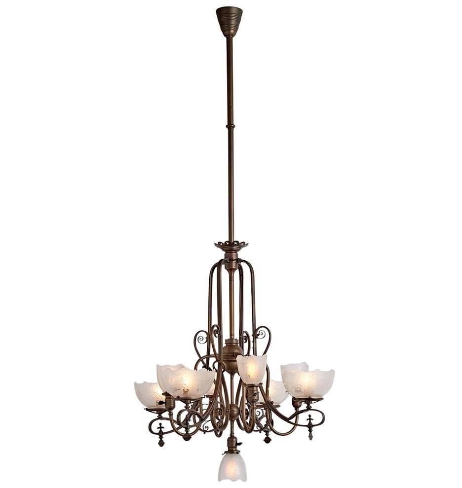 A rare survivor from the early days of electricity, this gas/electric nine-light stunner, now fully electrified, has all the transitional character that makes lighting of the turn of the century so interesting. The remarkable reeded rectangular