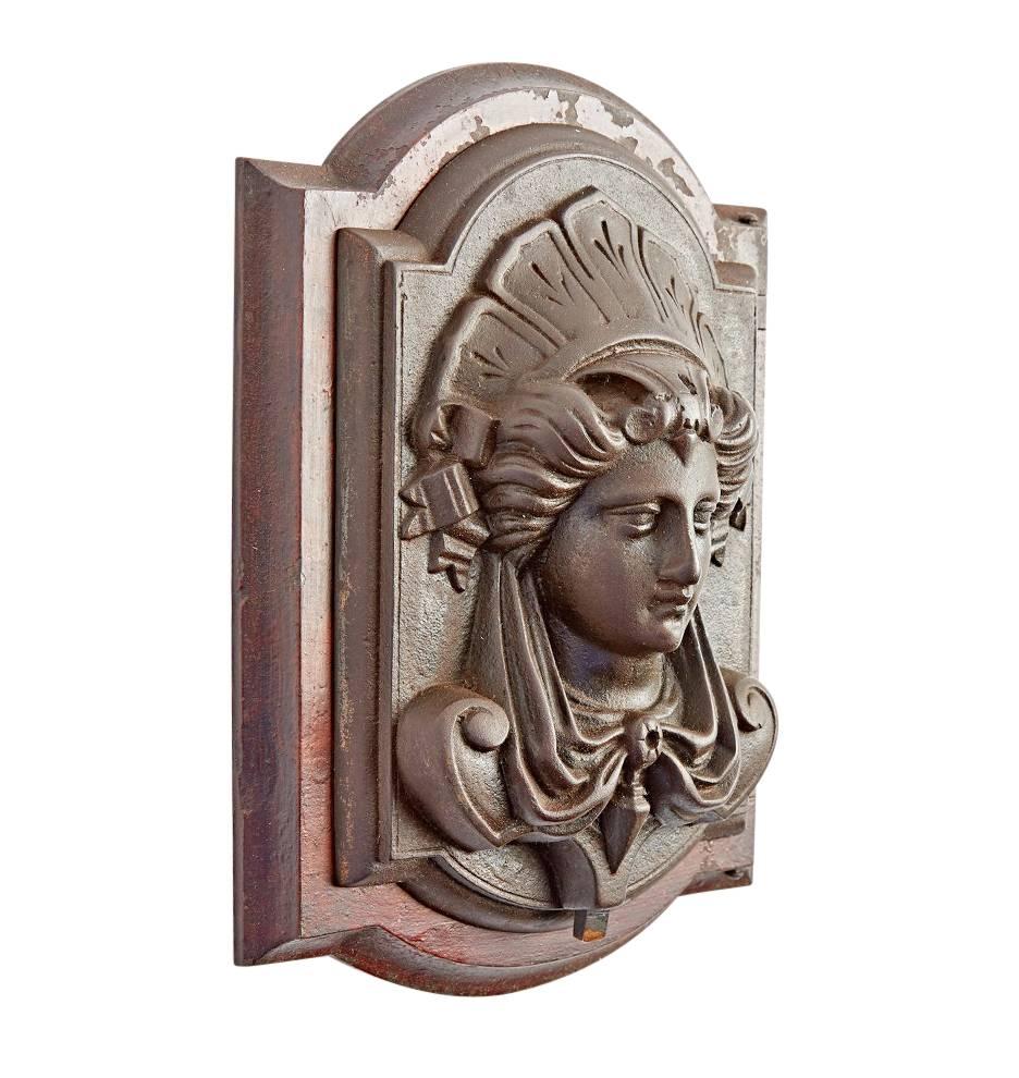 Beautifully cast in bronze via the lost wax method, this impressive knocker will bring the classical Revival right to your door. The piece would have been mounted to a grand entry door, where it would serve as a speak easy or pass through. At the