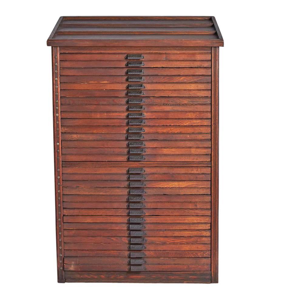 This handsome solid oak flat file cabinet features very few decorative flourishes, but is truly overflowing with character. The wear and age in the wood is wonderful and (like all good patina) impossible to replicate. Built by the Hamilton Type