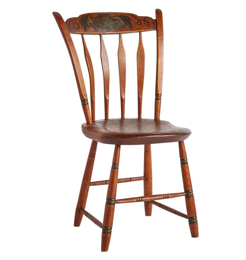 Beautiful set of five colorfully painted Hitchcock-style chairs from the mid-19th century, likely from Pennsylvania. They feature shaped crest rails over arrow backs, with nicely carved plank seats and lovely hand-painted grape leaf motifs. All of