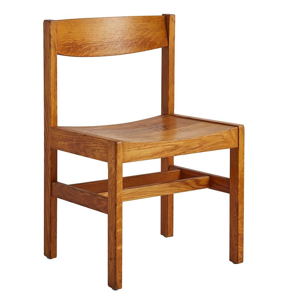 Made of simply carved and stained oak, this set of dining chairs is a wonderful and unique example of Modernist design. As a complete set of four, you'll have plenty of seats for every history-loving guest at your table.