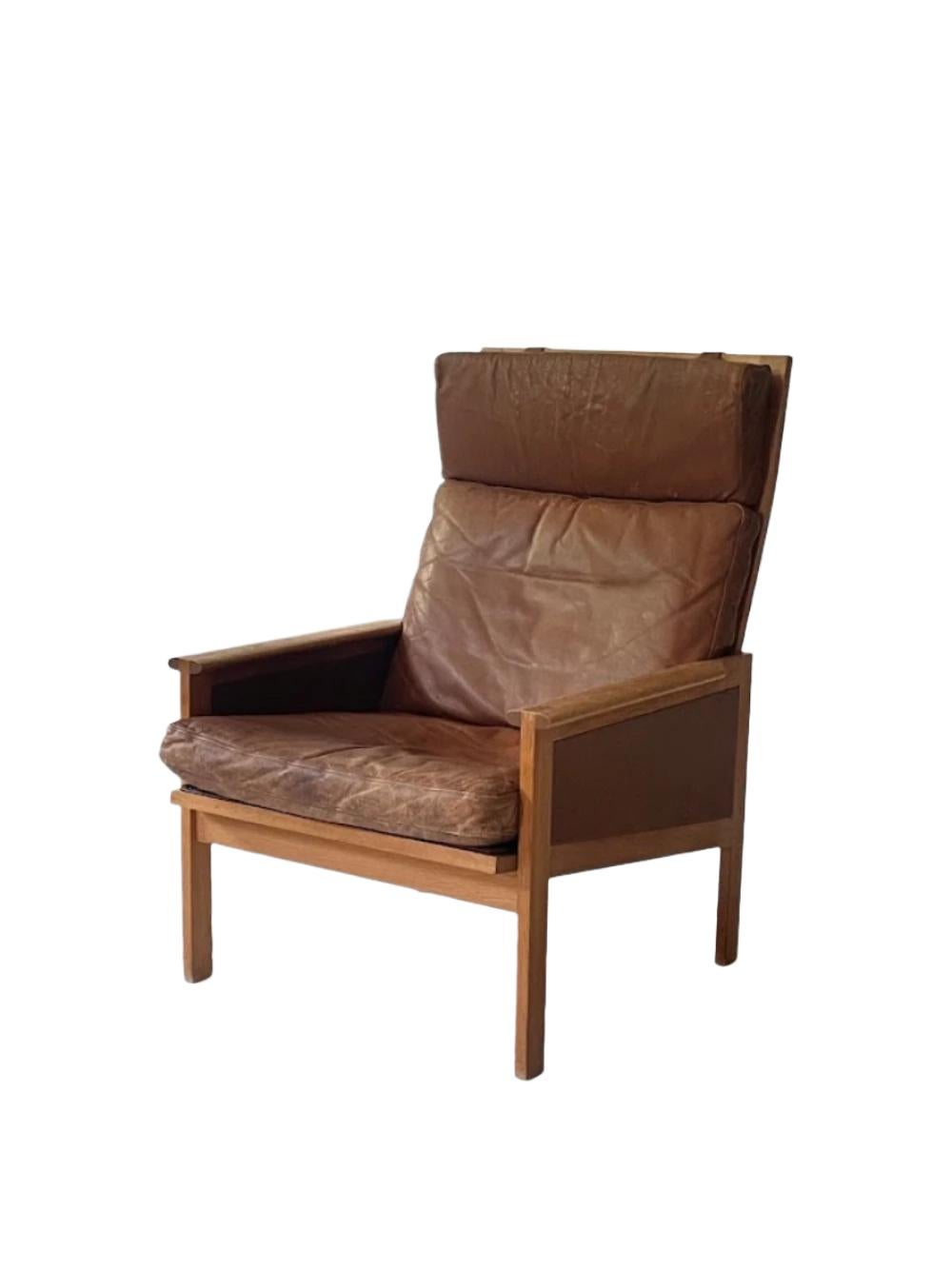 Cette chaise longue en cuir d'Illum Wikkelsø pour Eilersen, fabriquée dans les années 1960 au Danemark, est dotée d'accoudoirs personnalisés et de coussins en cuir fixés à l'aide de sangles en cuir. Ces éléments de conception réfléchis améliorent le
