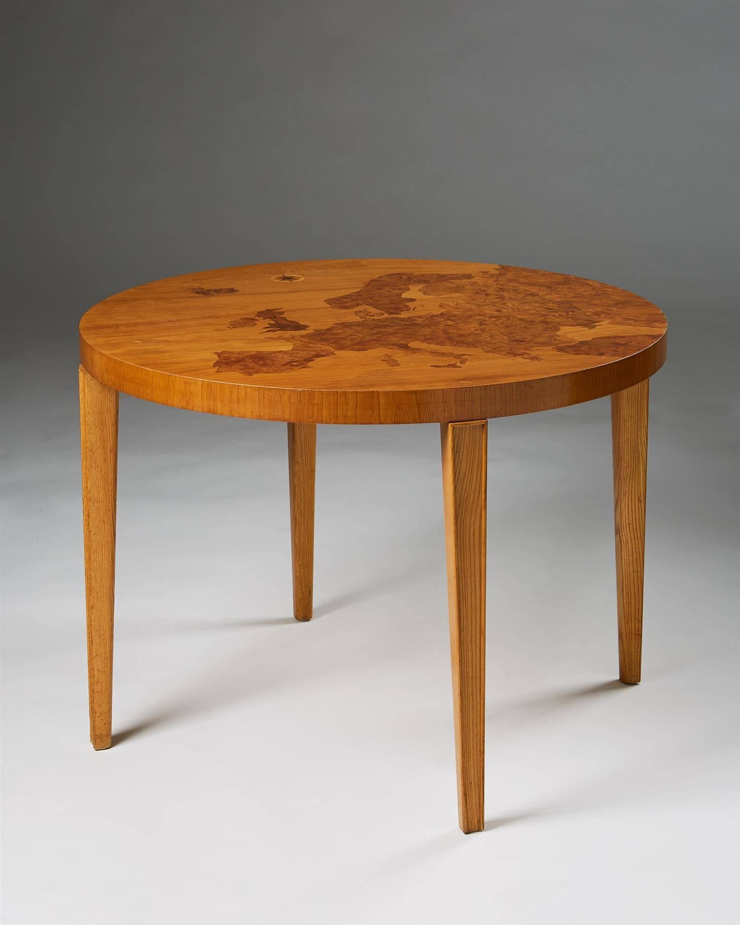 Occasional table, anonymous, Sweden, 1940s.
Marquetry map of Europe in various woods inlays.

Measures: H: 59 cm / 23 1/4''
D: 80 cm / 31 1/2''.