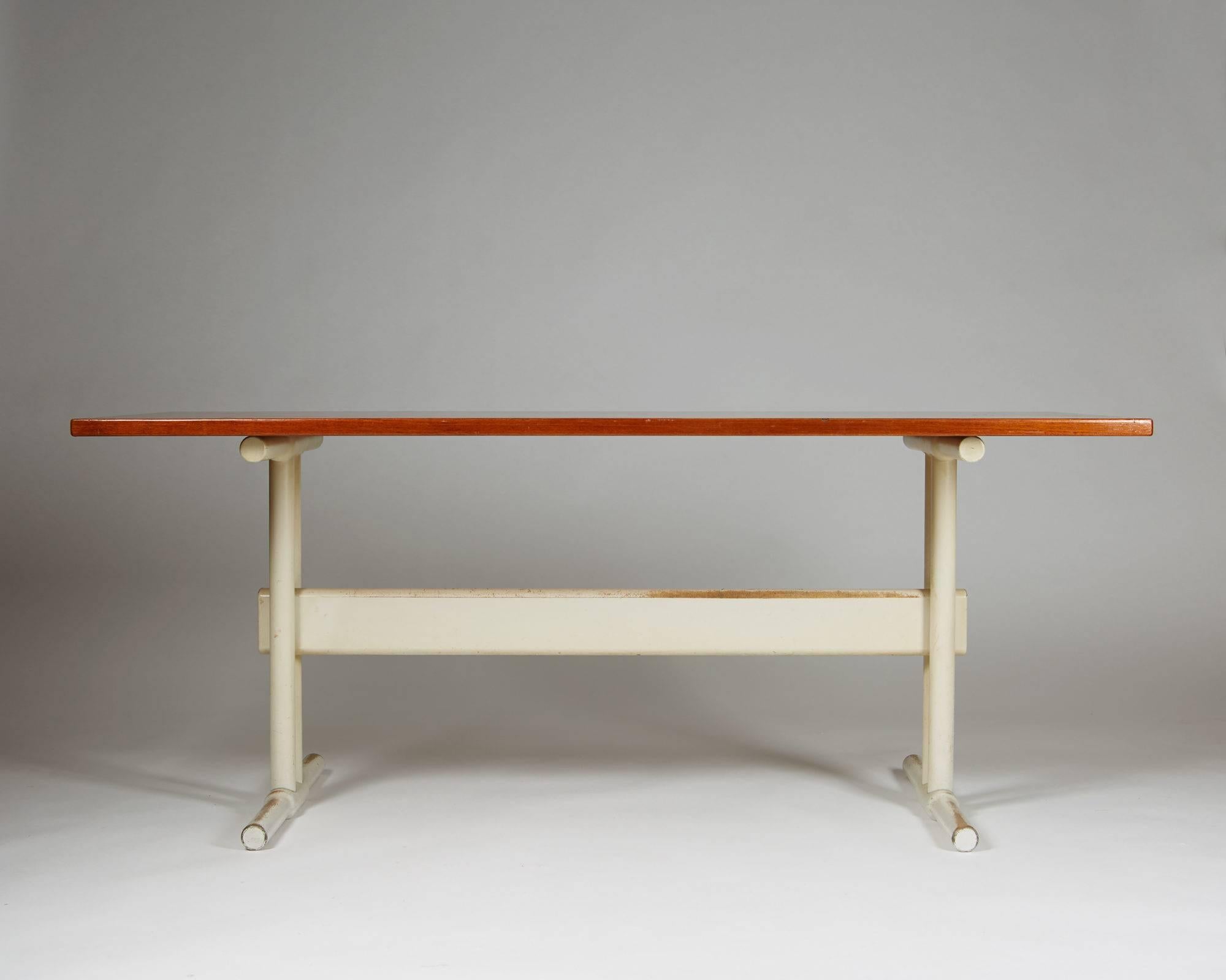 Desk/dining table, anonymous, Denmark, 1950s.
Teak top with lacqured wood base.

H: 72 cm/ 28 1/2''
L: 175 cm/ 5' 9''
D: 75 cm/ 29 1/2''.