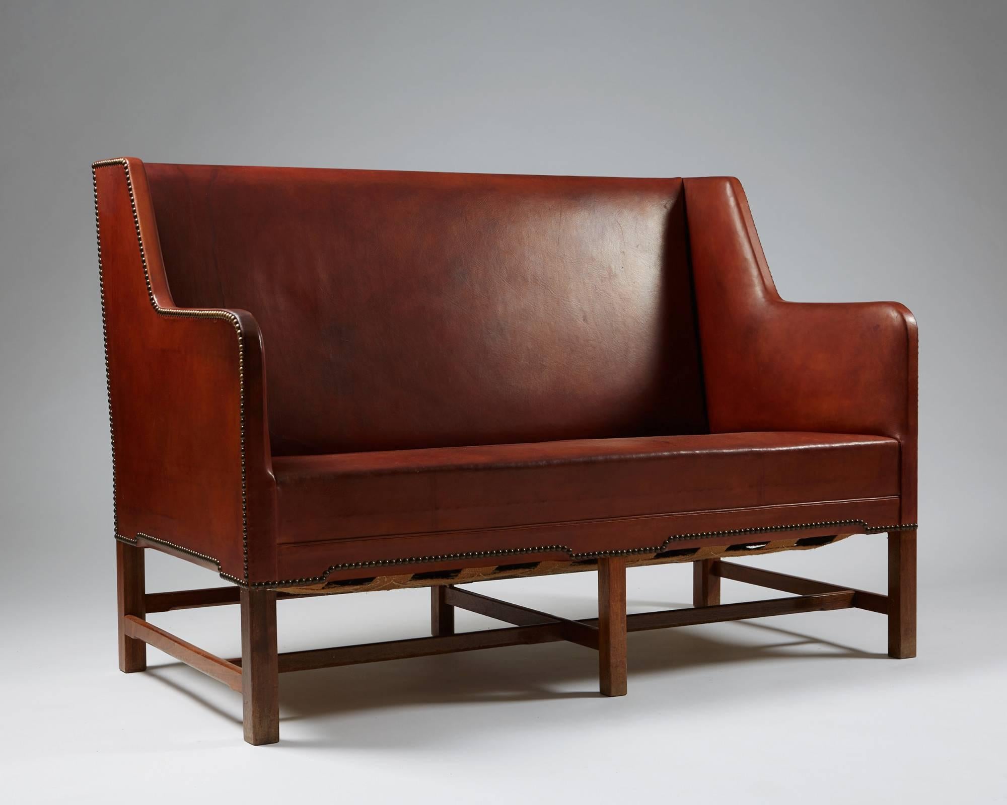 Sofa model 5011 designed by Kaare Klint for Rud Rasmussen, Denmark, 1935
Original leather, mahogany and brass. Back covered in original canvas.

H: 92 cm/ 3' 
L: 132 cm/ 4' 4''
D: 65,5 cm/ 26''
Seat height: 41 cm/ 16''