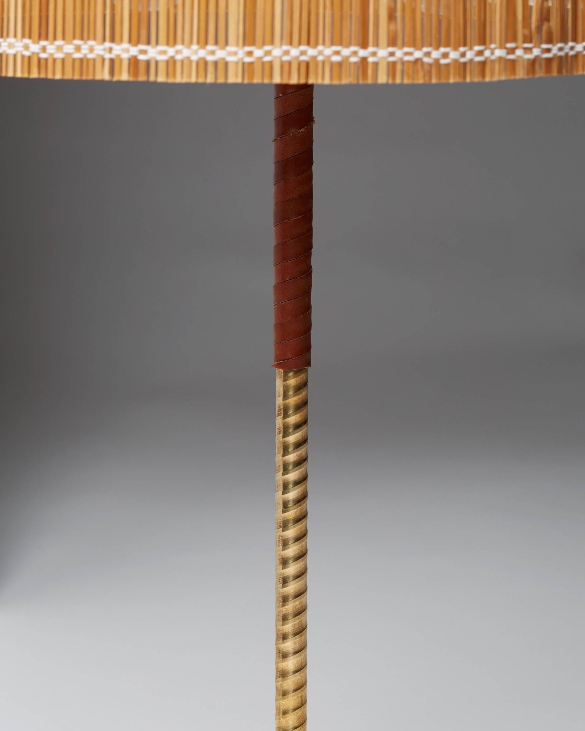 Table lamp 9205 designed by Paavo Tynell for Taito Oy, Finland, 1950s.
Brass, leather and cane.
     