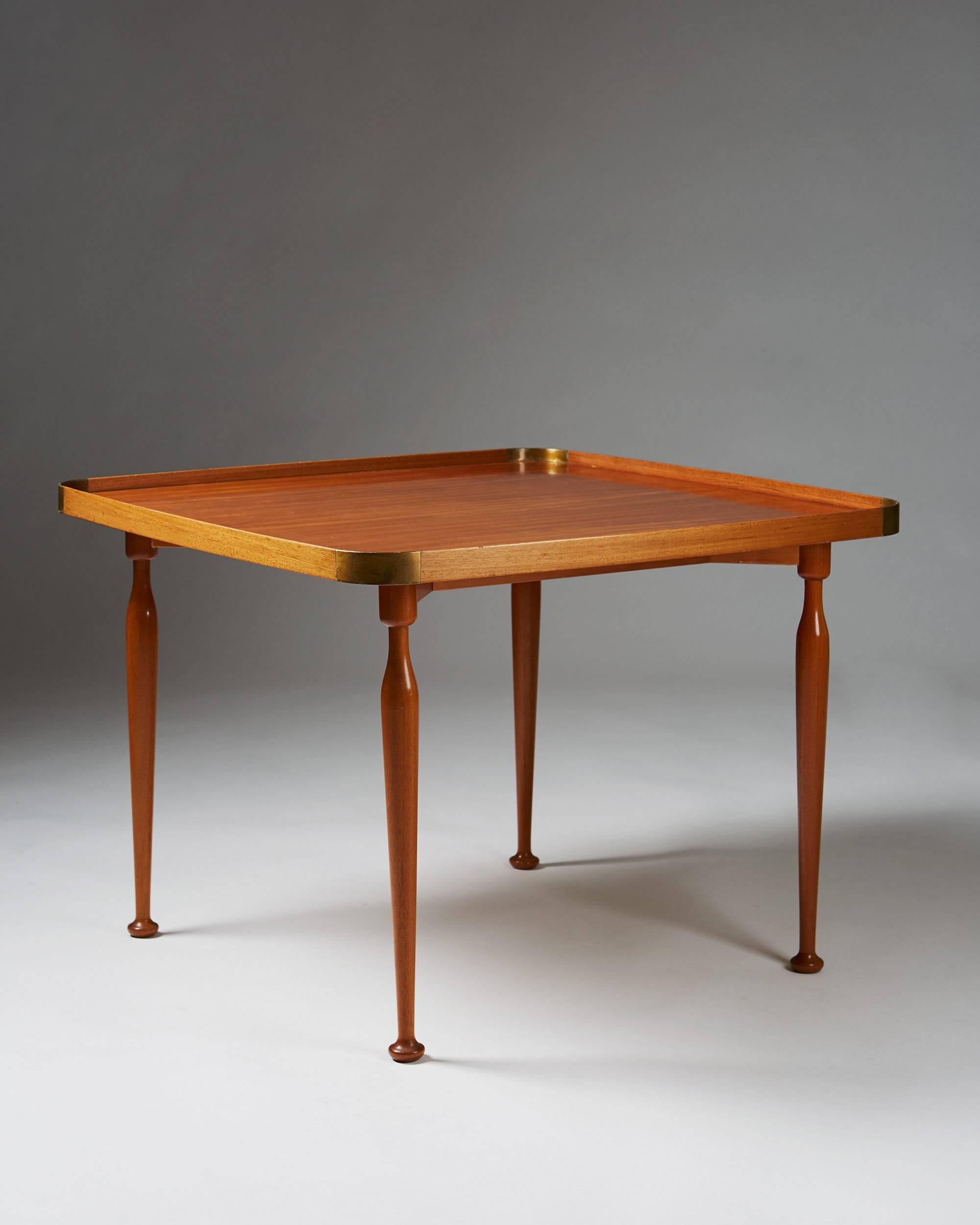 Occasional table model 1074 designed by Josef Frank for Svenskt Tenn, Sweden, 1950s.
Mahogany and brass.