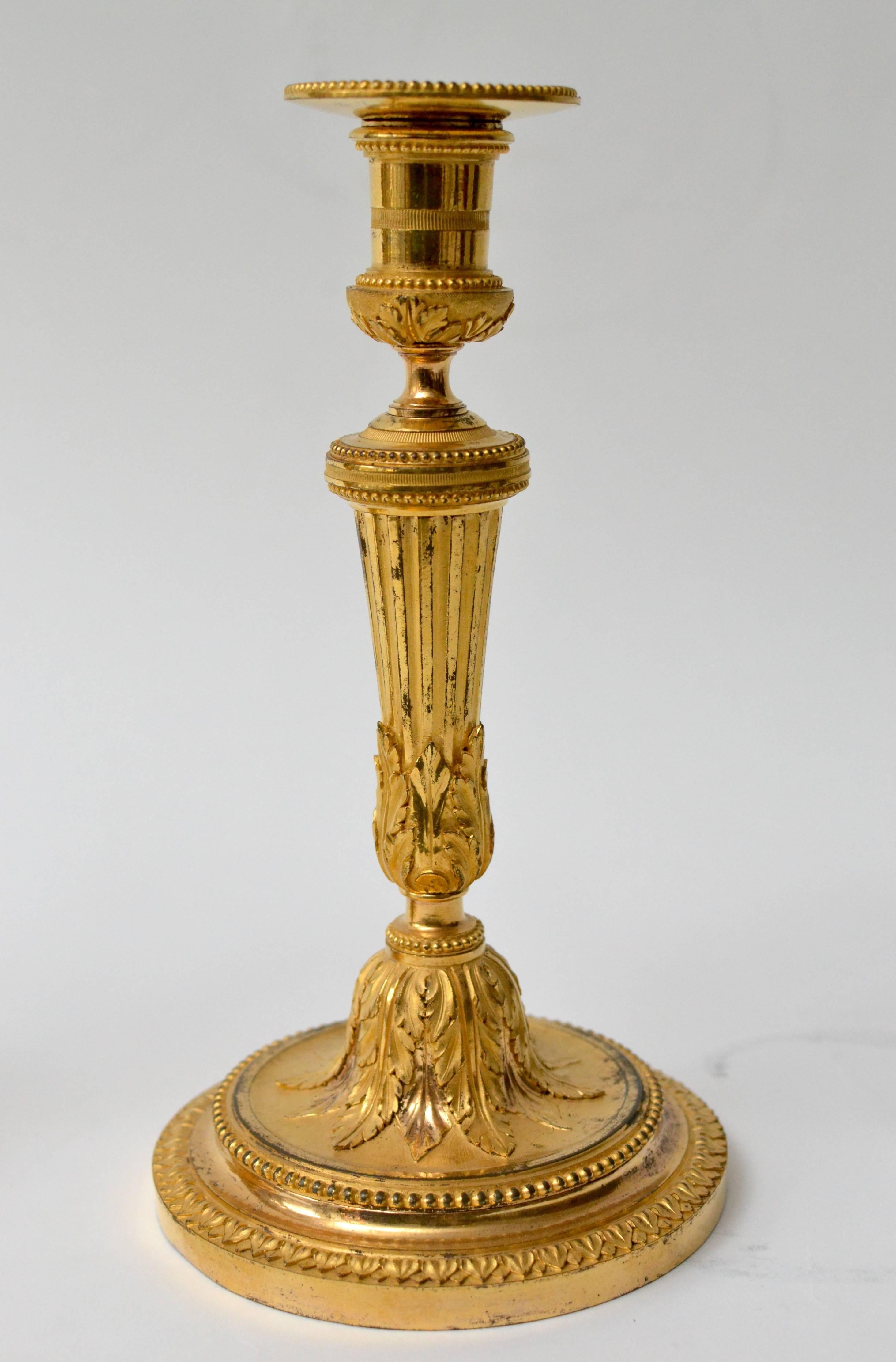 A pair of Louis XVI gilt bronze candlesticks.