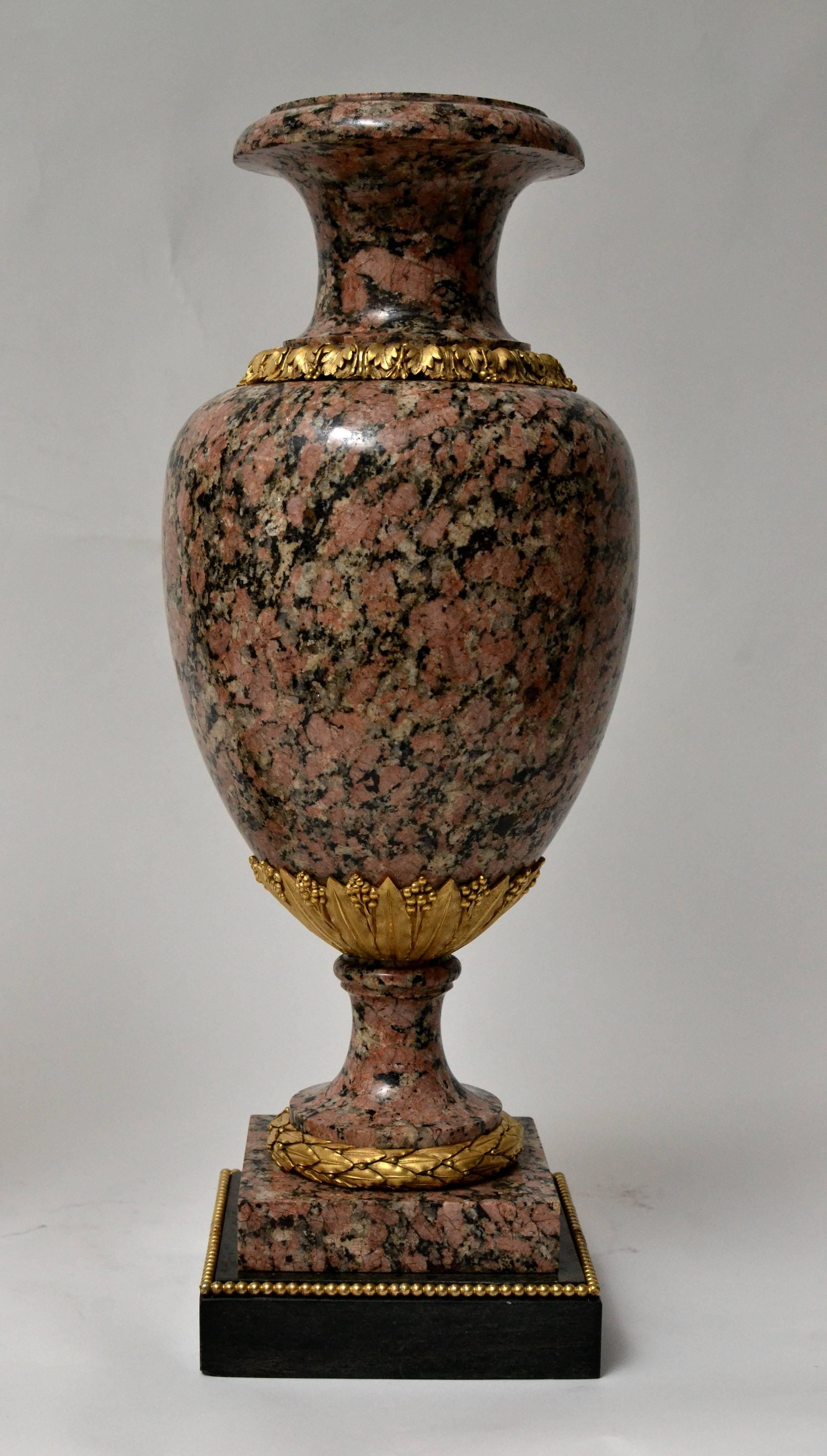 A large  pair of ormolu mounted Louis XVI style granite urns, 19th century.