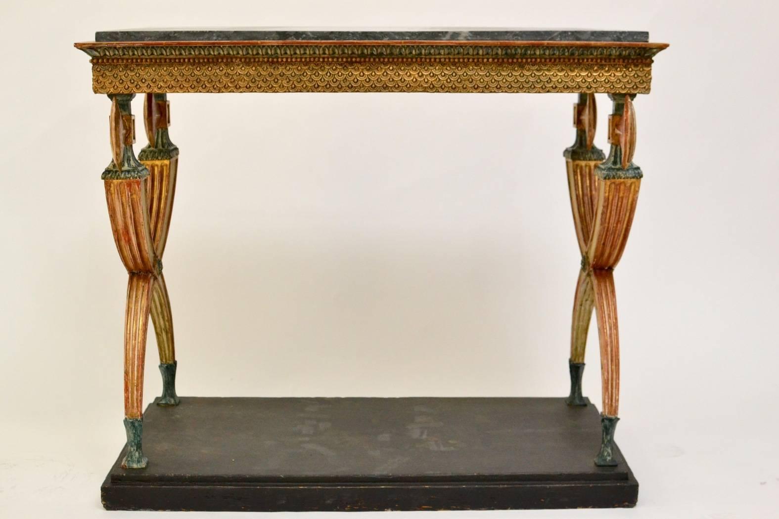 Swedish empire console table a with a marble top of an unusual model attributed to Jonas Frisk, working in Stockholm, 1805-1824. Gilded and painted. The top Bleu Turquin marble.