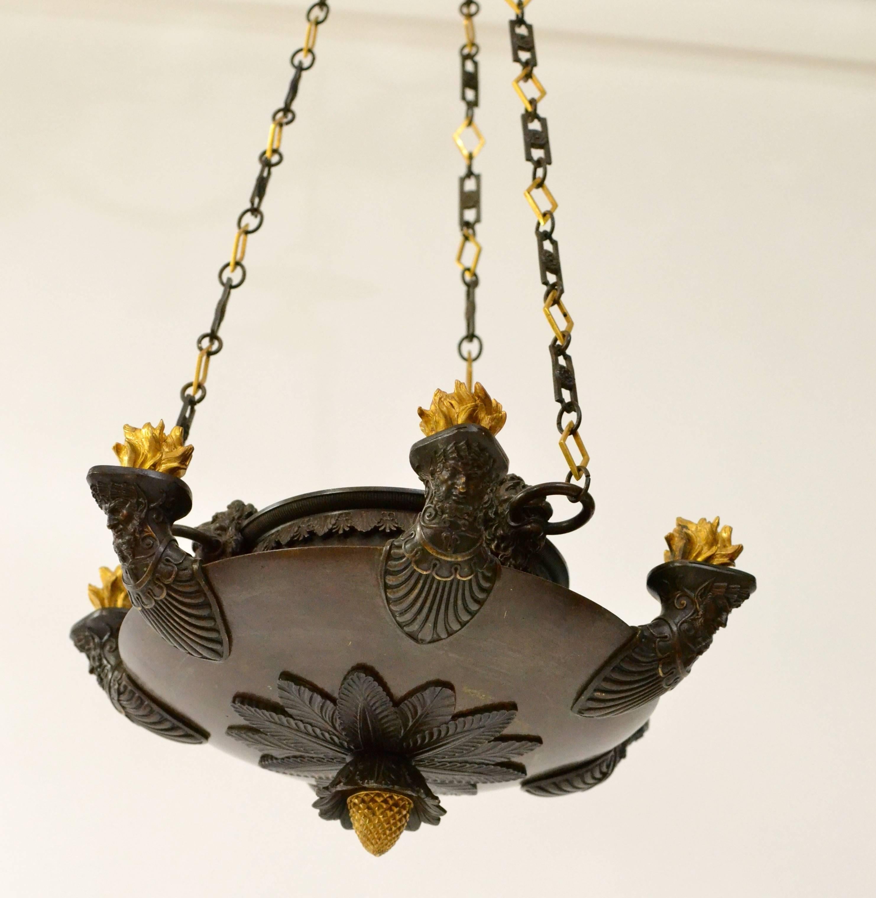A patinated and gilt bronze Empire chandelier of fine quality.