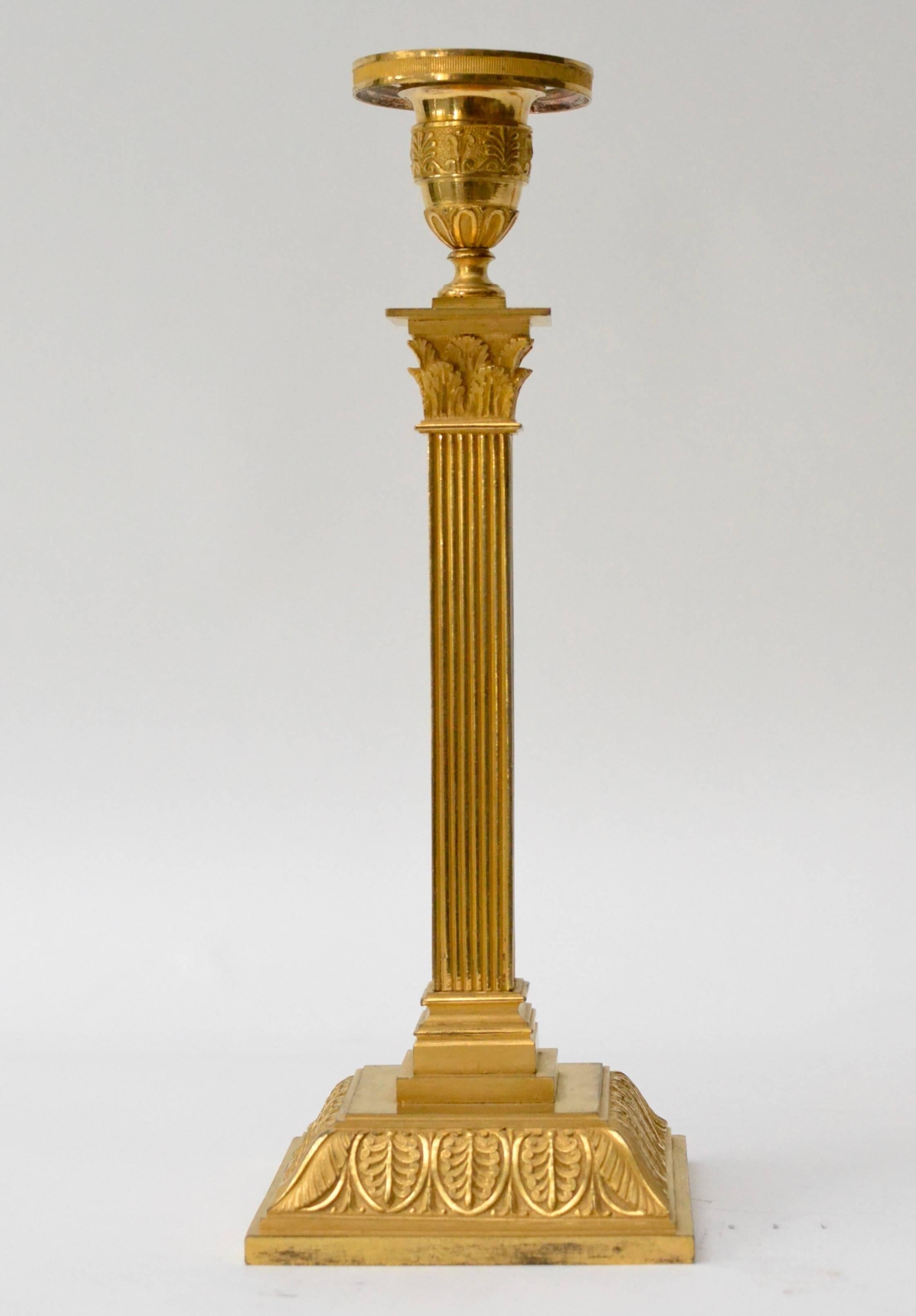 A pair of Empire gilt bronze candlesticks, possibly Vienna, early 19th century.
 