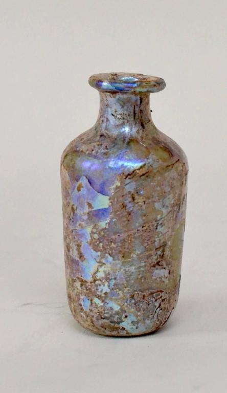 A Roman iridescent glass flask, 1st-3rd century AD.
