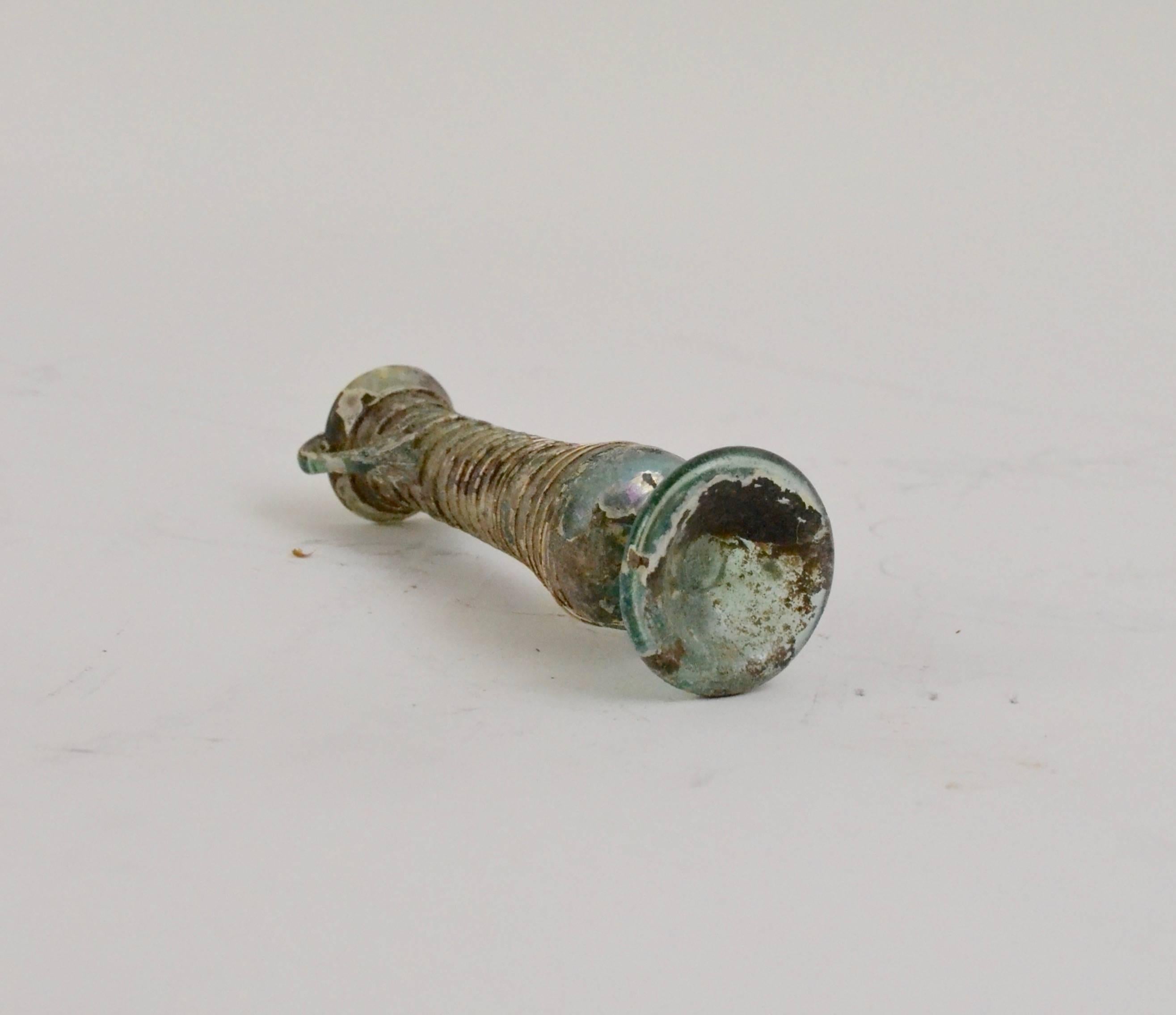 A Roman glass bottle, 1st-3rd century AD.