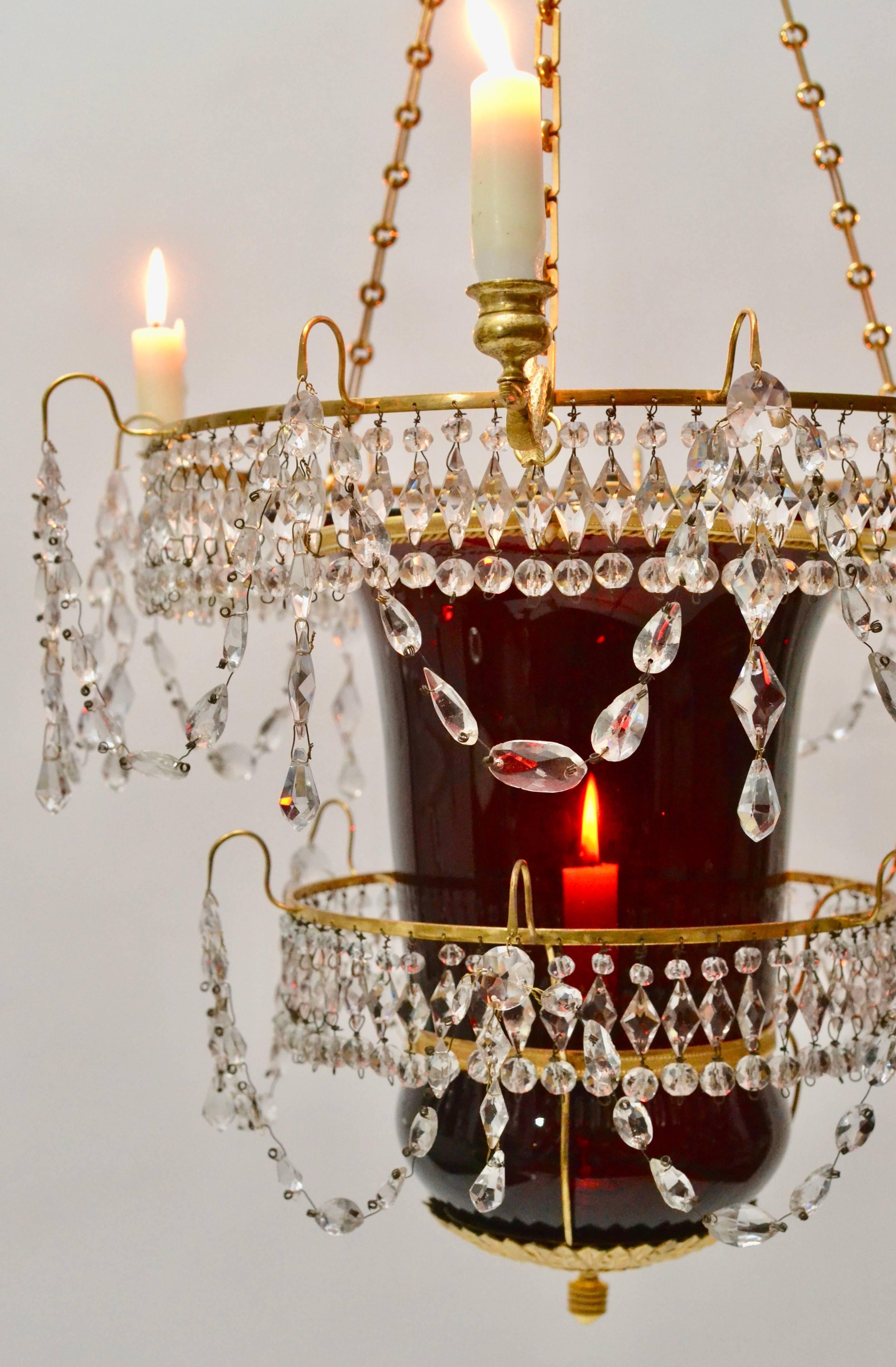 A very fine Russian Empire lantern chandelier with ruby colored glass and clear crystals in a gilt bronze suspension. First half of the 19th century.