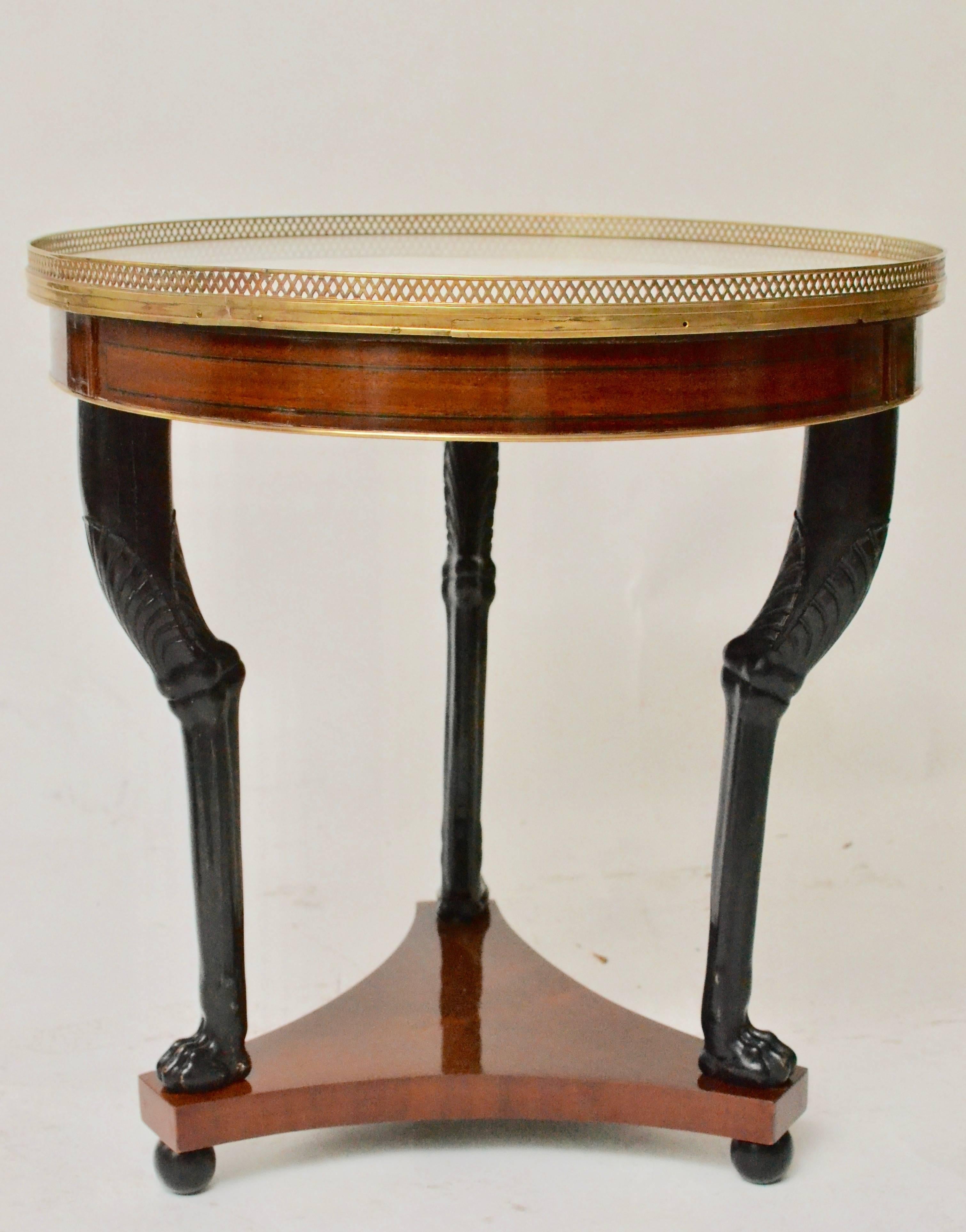 A French Directoire mahogany guéridon table with a white marble top and gilt bronze mounts, late 18th century.