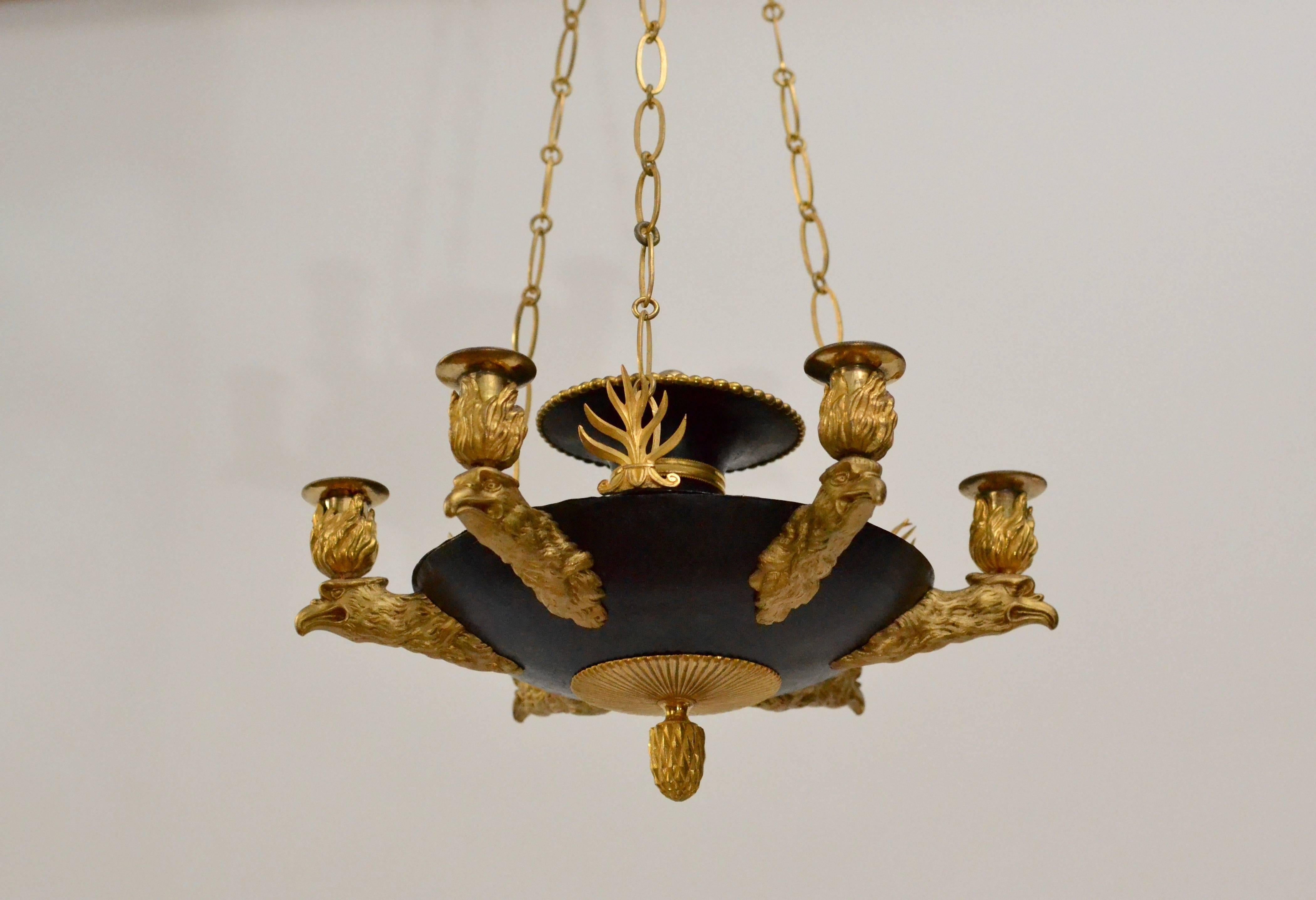 A Swedish six-light gilt bronze and patinated Empire chandelier, circa 1810-1820.