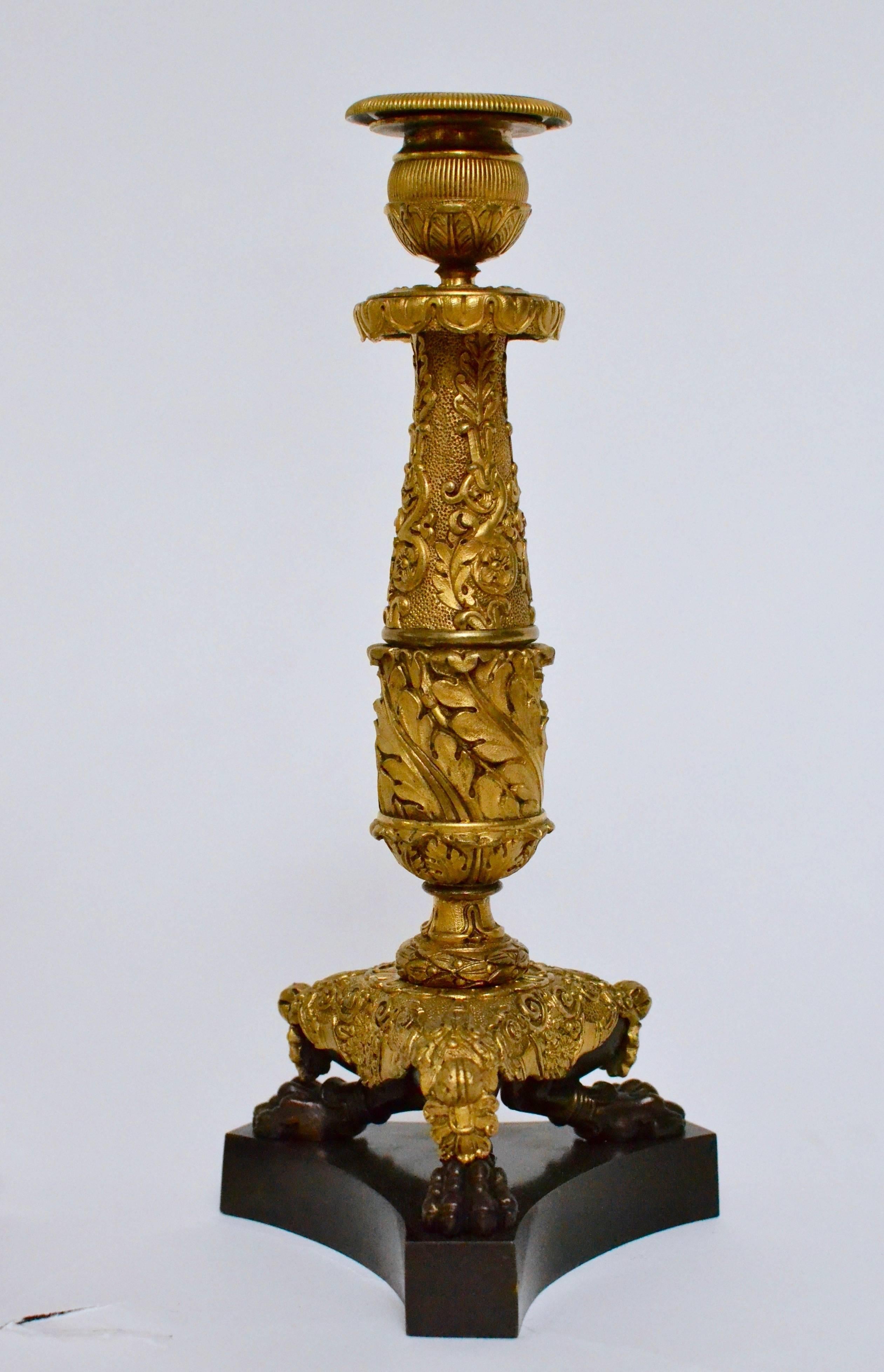 A pair of Empire gilt bronze candlesticks, circa 1825.